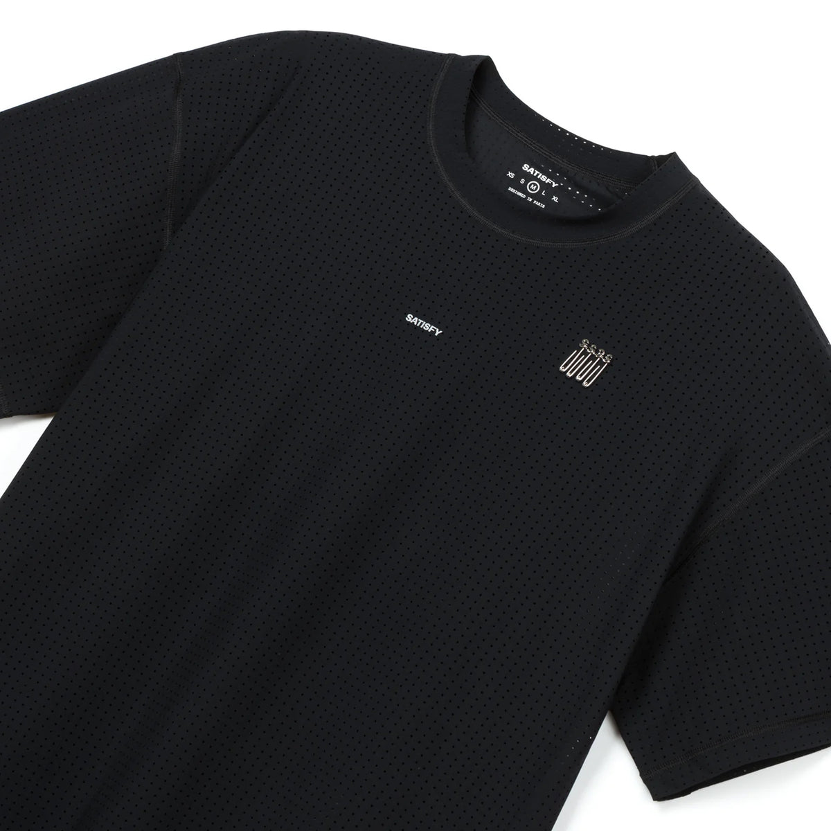 Satisfy Space-O Tee Black close-up front showing precision punched openings for targeted airflow, reflective SATISFY print and lightweight 120-gram Italian micro jersey construction