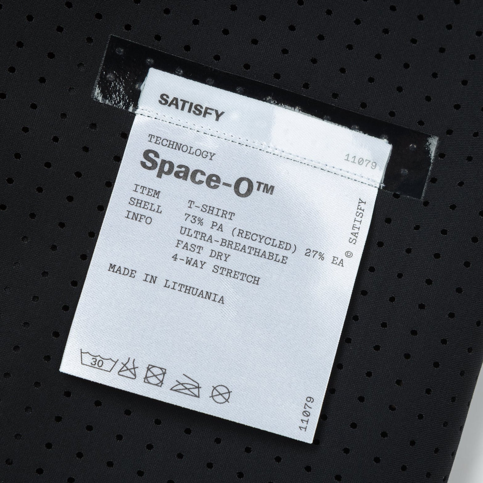 Satisfy Space-O Tee Black close-up of fully detachable exterior care label with nothing inside interfering with skin contact