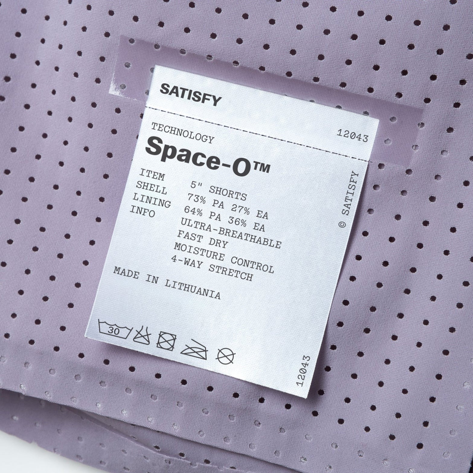 Satisfy Space-O™ 5 Inch Distance Shorts in Dusk — closeup showing fully detachable exterior care label on Space-O™ perforated micro jersey fabric