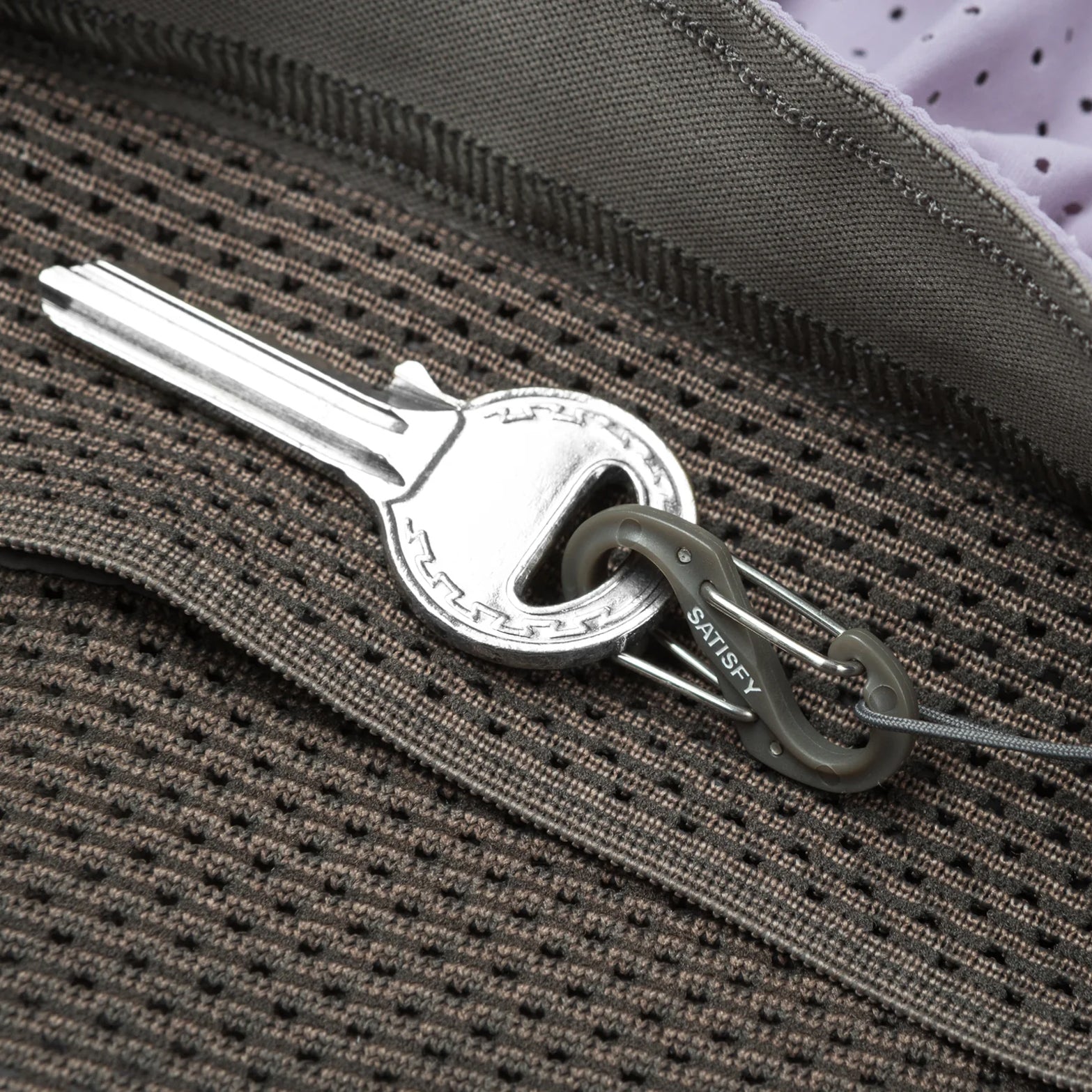 Satisfy Space-O™ 5 Inch Distance Shorts in Dusk — closeup showing mini S-Carabiner integrated into the double waistband for securing essentials on the run