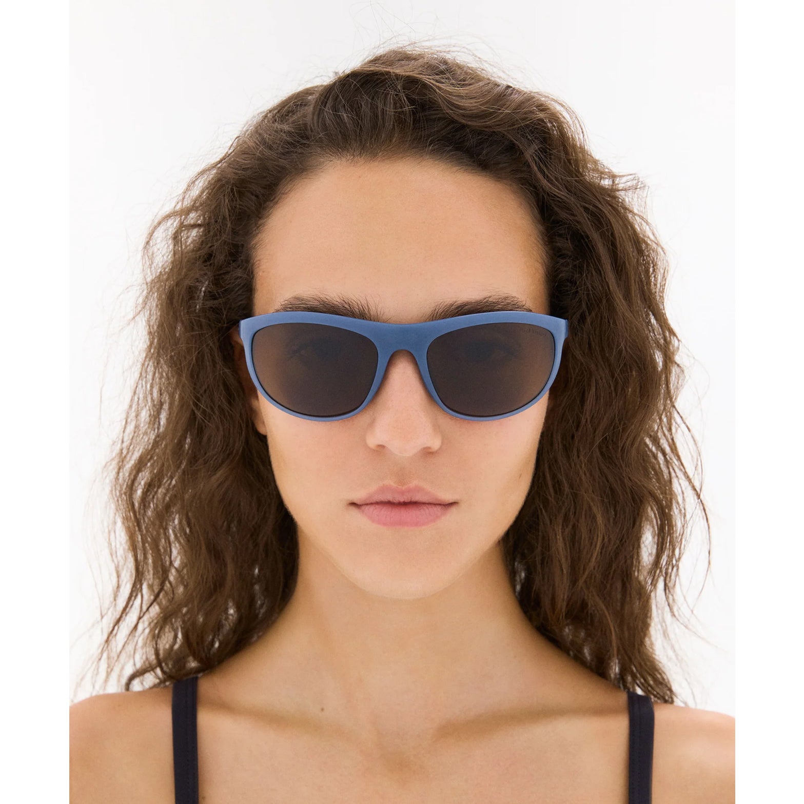 District Vision Takeyoshi Altitude Master in Cold Water D+ Copper — worn on female model showing eight-base frame fit, cold water colourway and D+ Copper lens in natural light