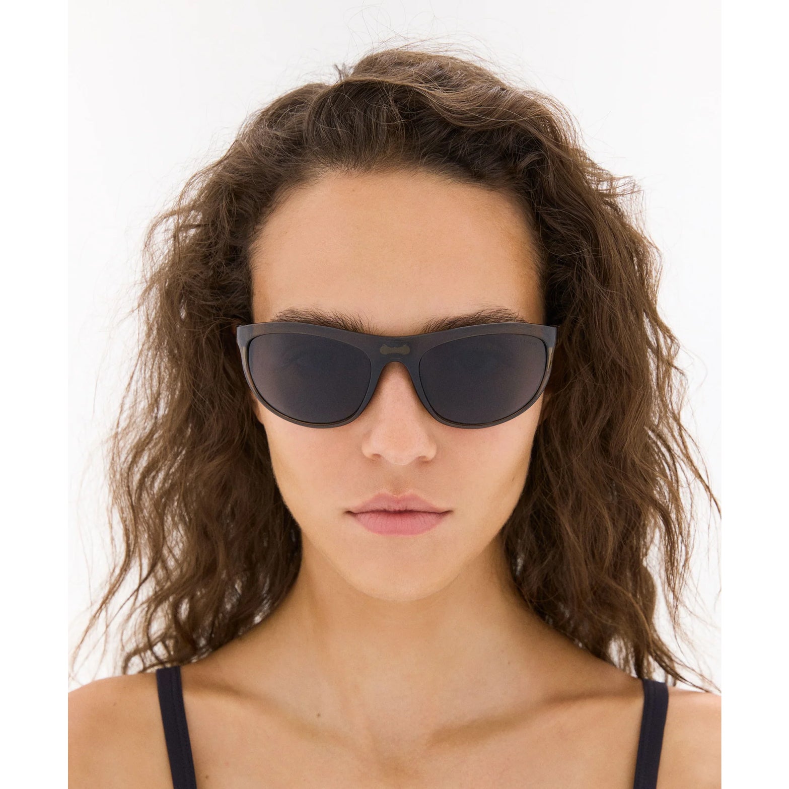District Vision Takeyoshi Altitude Master in Liquid Moss D+ Water Grey — worn on female model showing eight-base frame fit, liquid moss colourway and D+ Water Grey lens in natural light