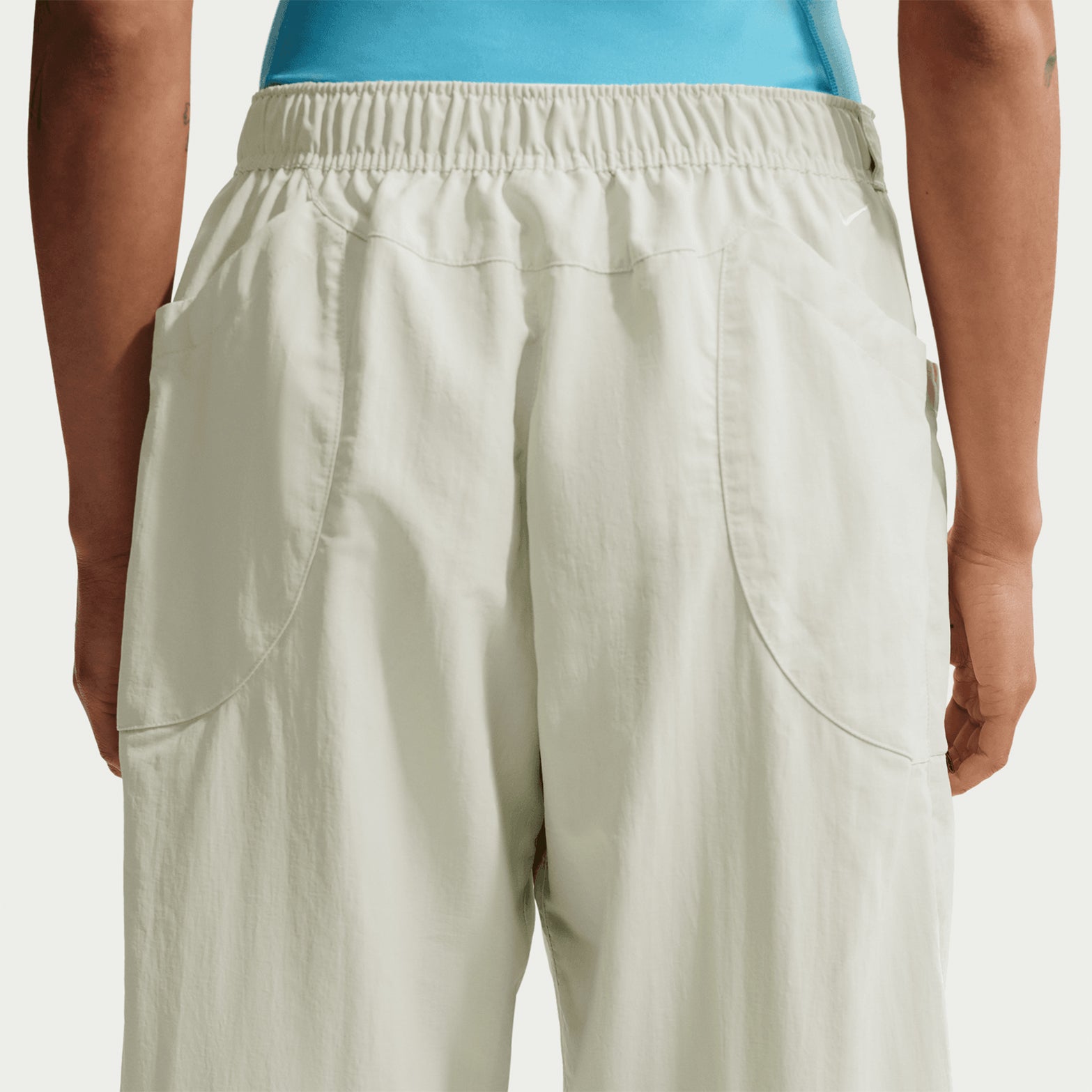Nike ACG Dolomiti women's trousers in Sea Glass / Black — back product shot showing sea glass 100% nylon construction