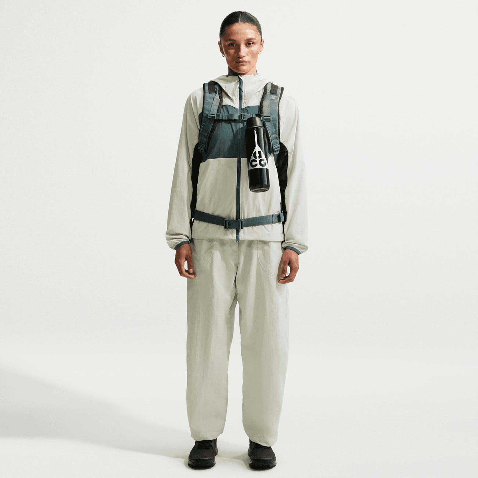 Nike ACG Dolomiti women's trousers in Sea Glass / Black — full body front view worn on model showing sea glass loose fit construction, black detailing and comfortable movement design for mountain terrain