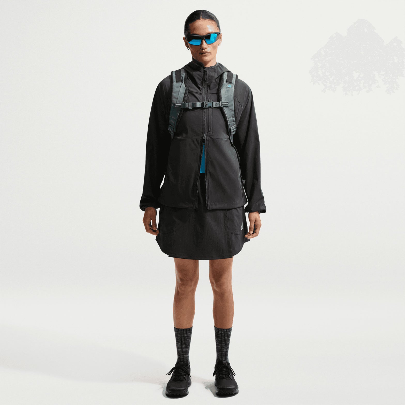 Women's Nike ACG Five Towers Skort Anthracite Summit White front full body view on female runner showing convertible skort design with buttons for switching between skirt, shorts or skort configuration