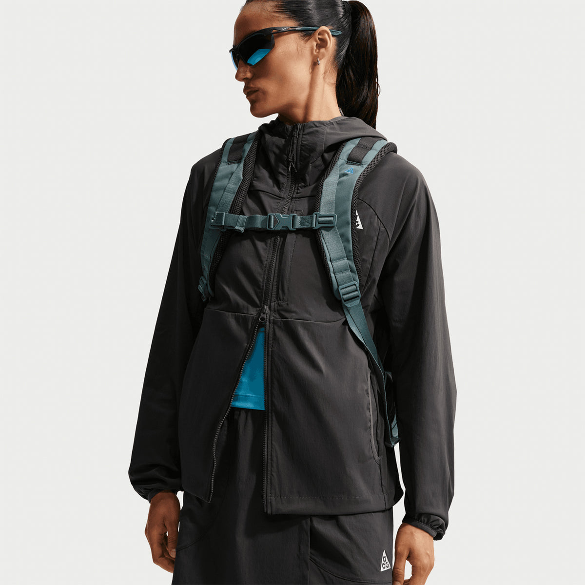 Women's Nike ACG Five Towers Skort Anthracite Summit White styled in complete ACG trail outfit with jacket and backpack showing convertible skort design for all-conditions mountain running and hiking