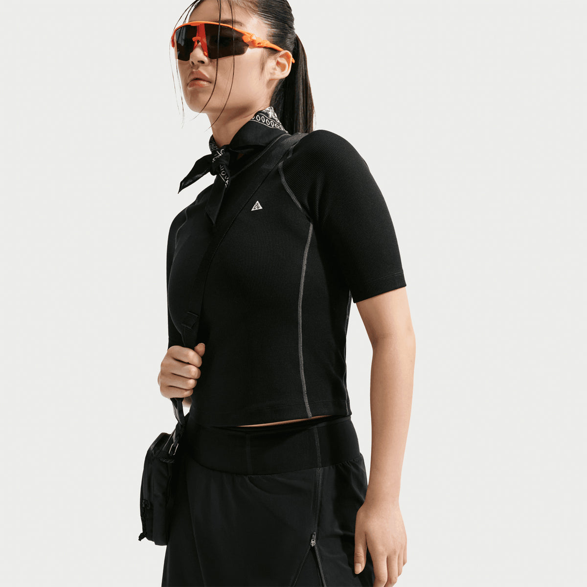 Women's Nike ACG High Stakes Skort Black Black Summit White side view on female trail runner showing lightweight convertible design with side pocket and built-in stretchy knit shorts for technical terrain