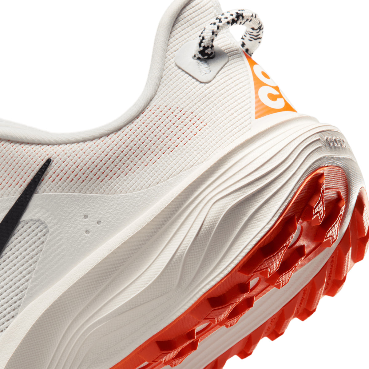 Nike ACG Pegasus Trail women's running shoe in Summit White / Phantom / Safety Orange / Black — angled side view showing summit white engineered mesh upper, wider forefoot stability design and phantom ReactX foam midsole with All Terrain Compound grip pattern
