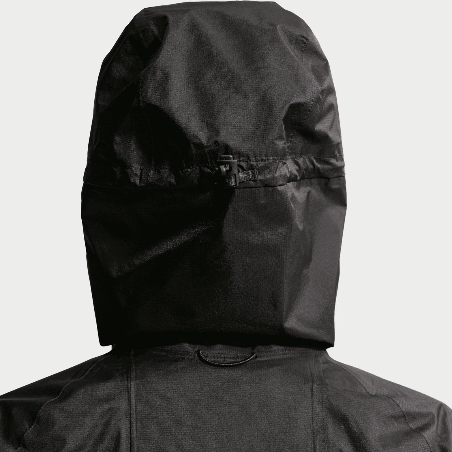 Women's Nike ACG Trailwind Storm-FIT ADV Jacket Black Summit White close-up of bungee-adjustable hood showing customisable coverage system with Storm-FIT ADV waterproof construction for unpredictable trail conditions