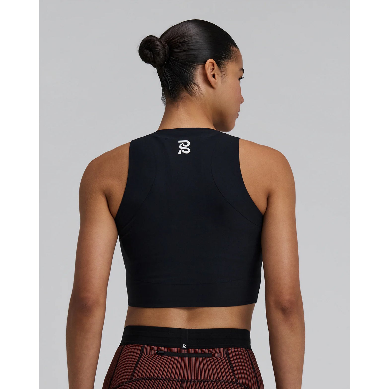 Women's Bandit Adapto Distance Race Top Black back view showing Acrofuse bonded construction with chafe-free seams, internal phone pocket and reflective branding