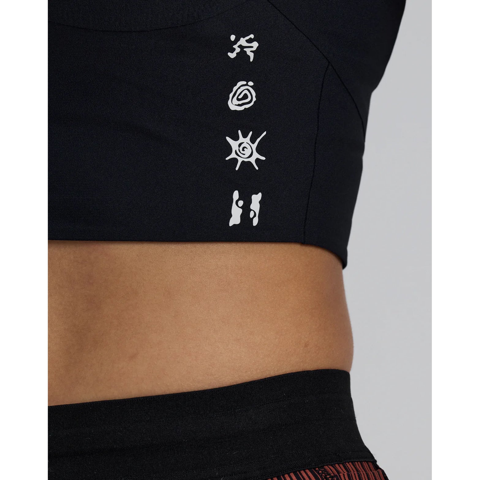 Women's Bandit Adapto Distance Race Top Black side close-up showing reflective branding details for low-light visibility