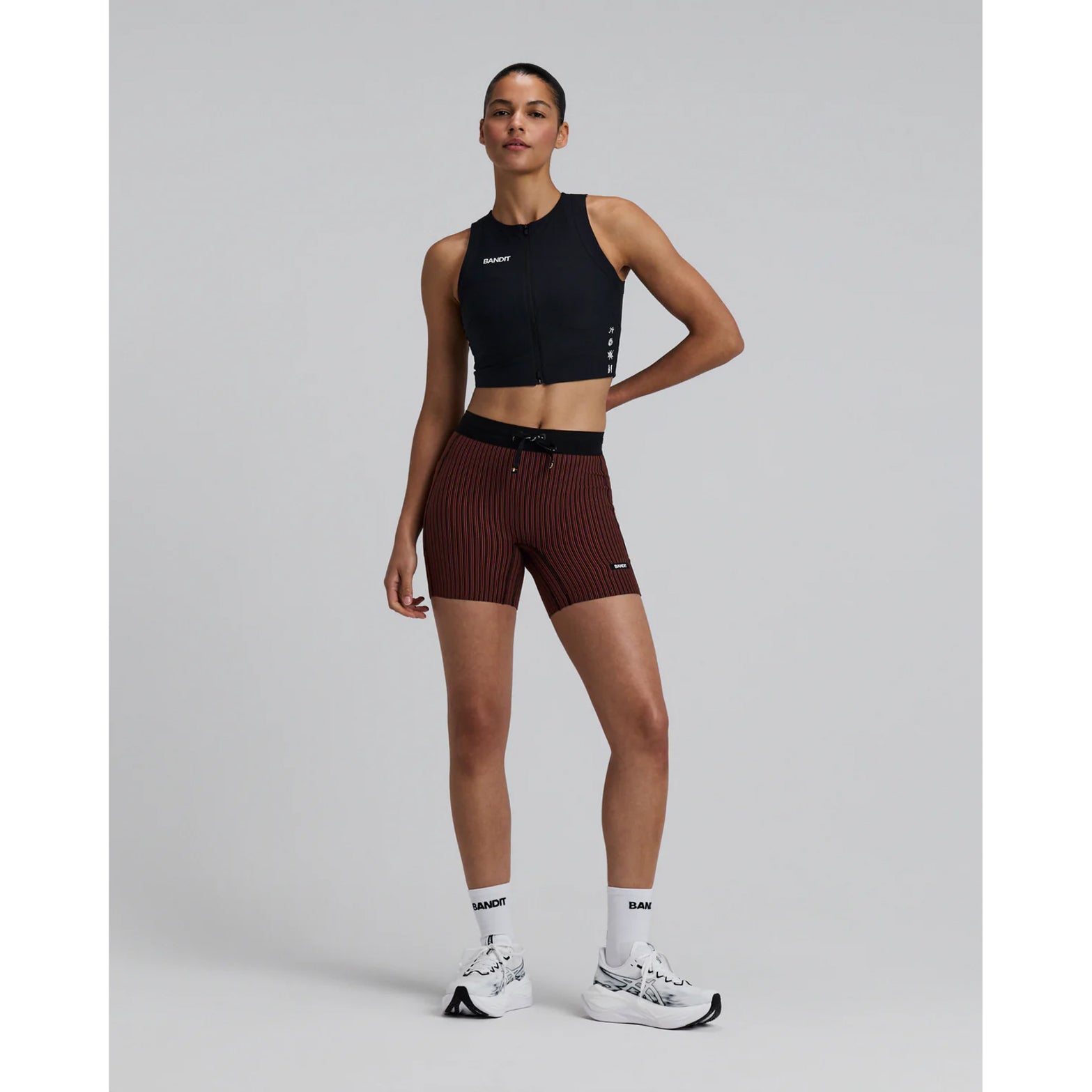 Women's Bandit Adapto Distance Race Top Black full body front view on female runner showing consistent compression hold with four-way stretch and 2-way zip