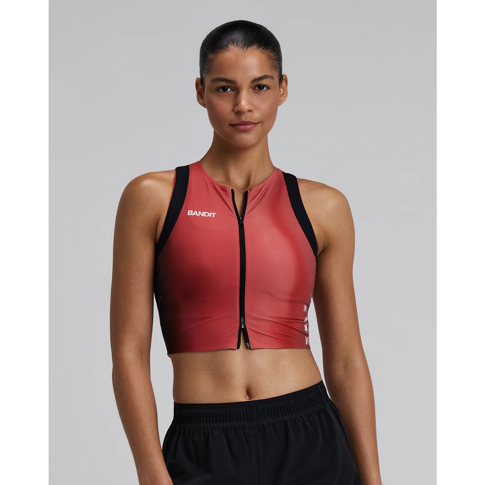 Bandit Adapto Distance Race Top women's in Salt Stain Rusted Apricot — front view worn on model showing four-way stretch compression fit, 2-way zip and salt stain rusted apricot Adapto™ fabric in motion