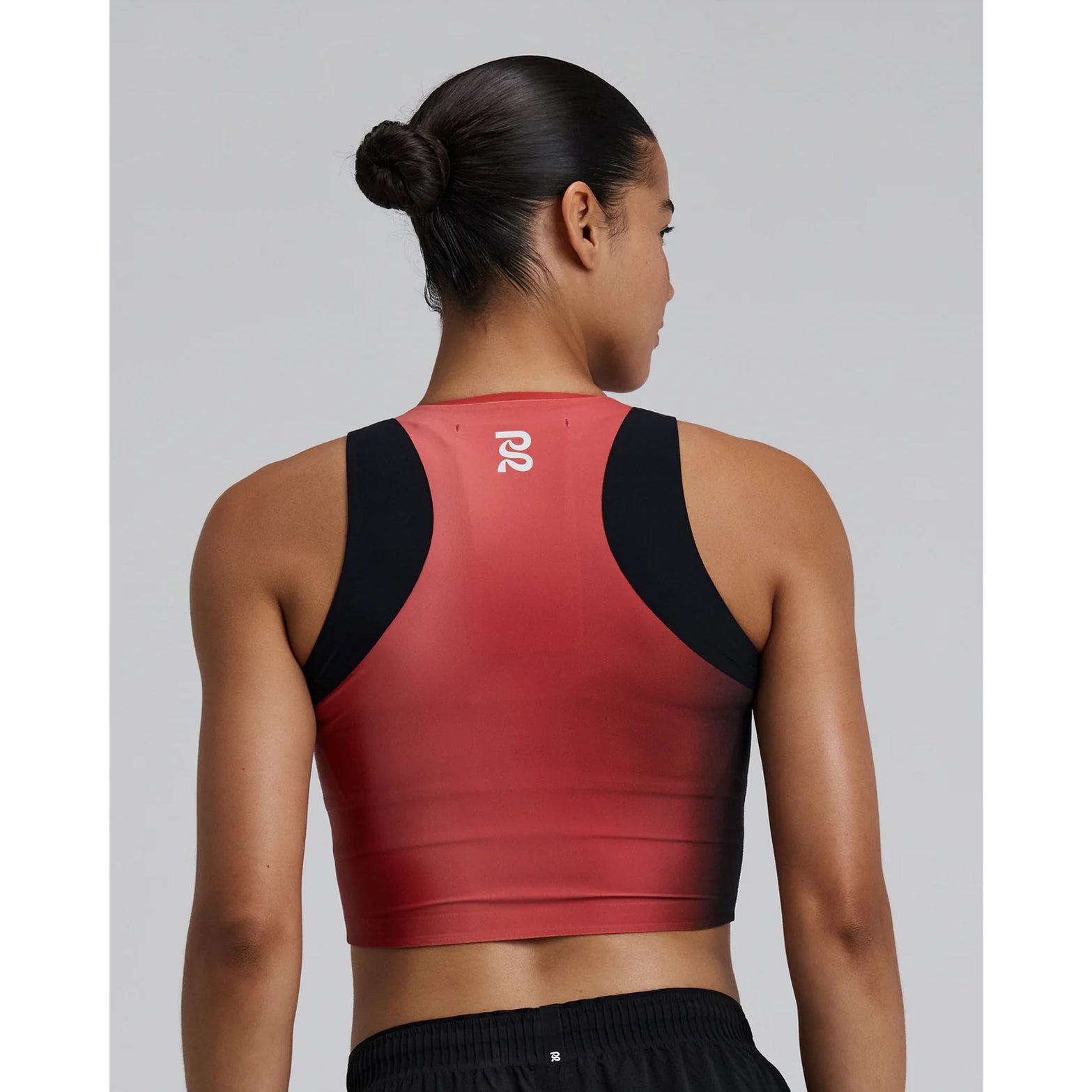 Bandit Adapto Distance Race Top women's in Salt Stain Rusted Apricot — back view worn on model showing Acrofuse™ bonded seam construction, internal phone pocket at back neck and salt stain rusted apricot compression fit