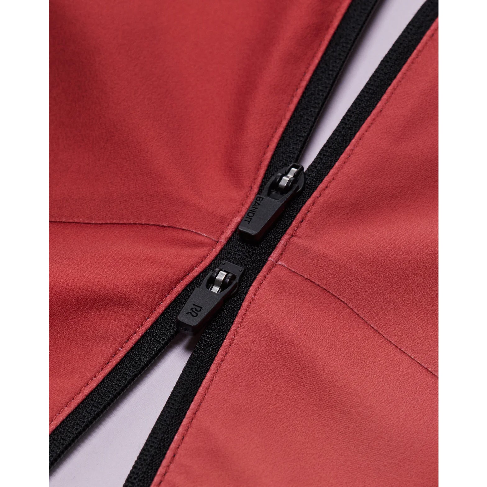 Bandit Adapto Distance Race Top women's in Salt Stain Rusted Apricot — closeup showing 2-way zip mechanism and pull detail on salt stain rusted apricot Adapto™ compression fabric