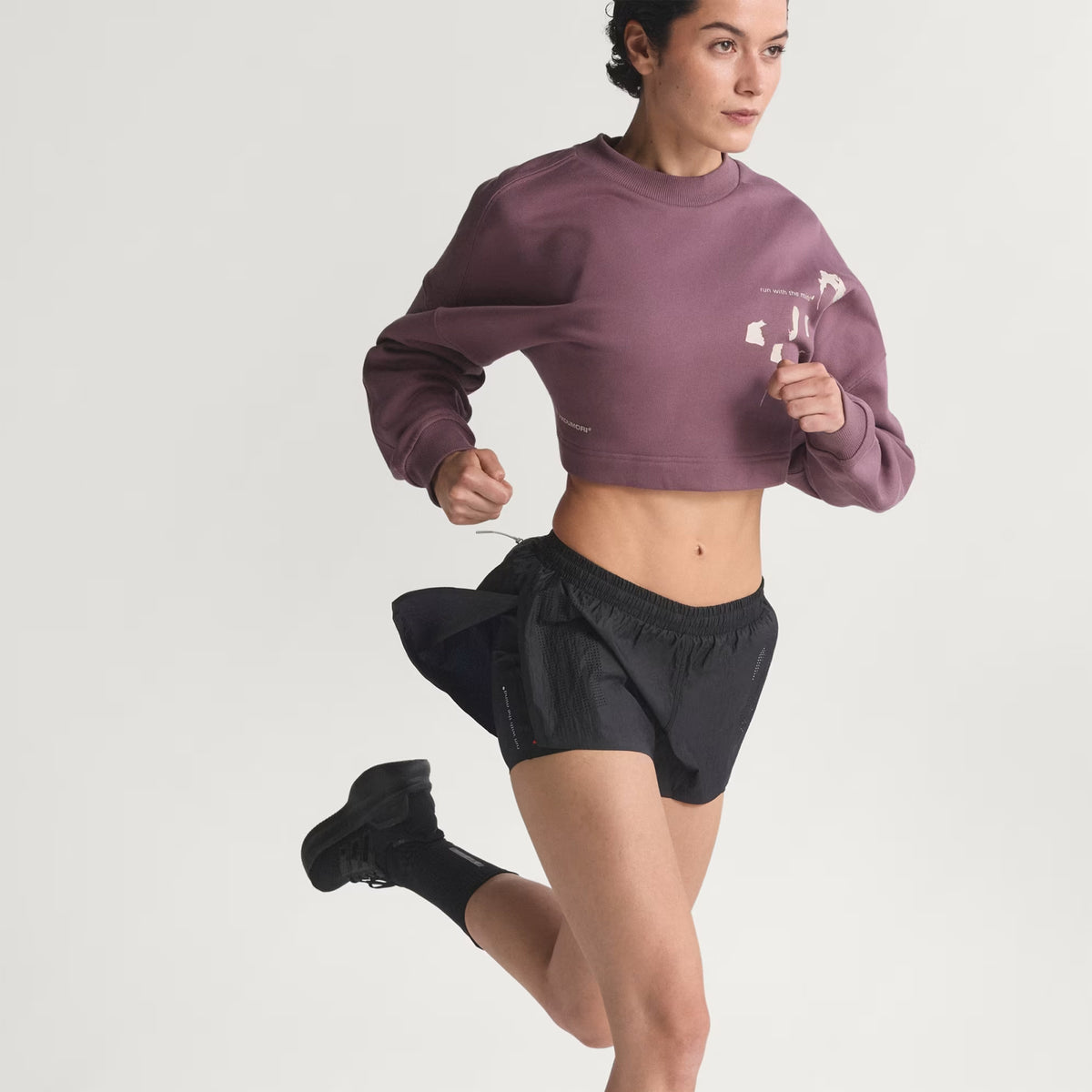 Women's adidas Adi365 H.Koumori Running Crew Top Shadow Fig on female runner in motion showing movement freedom with pre-shaped sleeves and sweat-wicking quick-drying French terry for warm-ups and training transitions