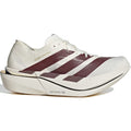 Off-white Women’s Adizero Adios Pro 5 running shoe featuring three maroon, polka-dotted stripes on the side and a thick LightstrikePro cushioning sole.