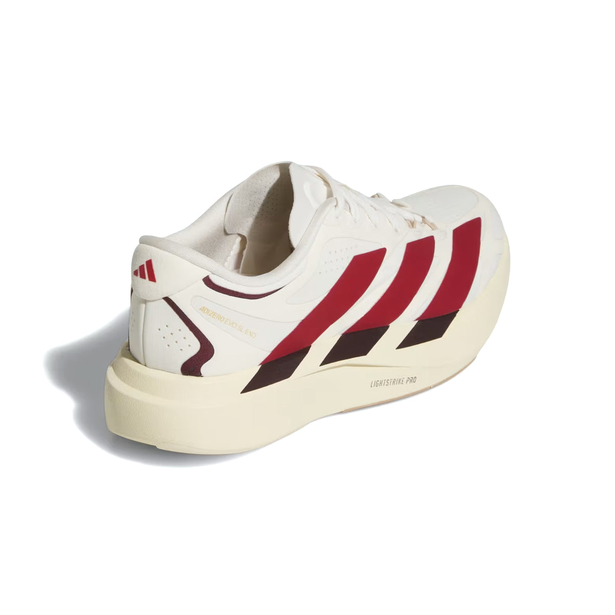 The Adidas Women’s Adizero EVO SL EXO Suede Running Shoes in Core White, Team Victory Red, and Cream White feature a white upper with red stripes and beige accents, a thick cream-colored sole with “LIGHTSTRIKE PRO” marked on the side, and advanced technology such as the EXOSKELETON Fit System for enhanced support and a lightweight feel.