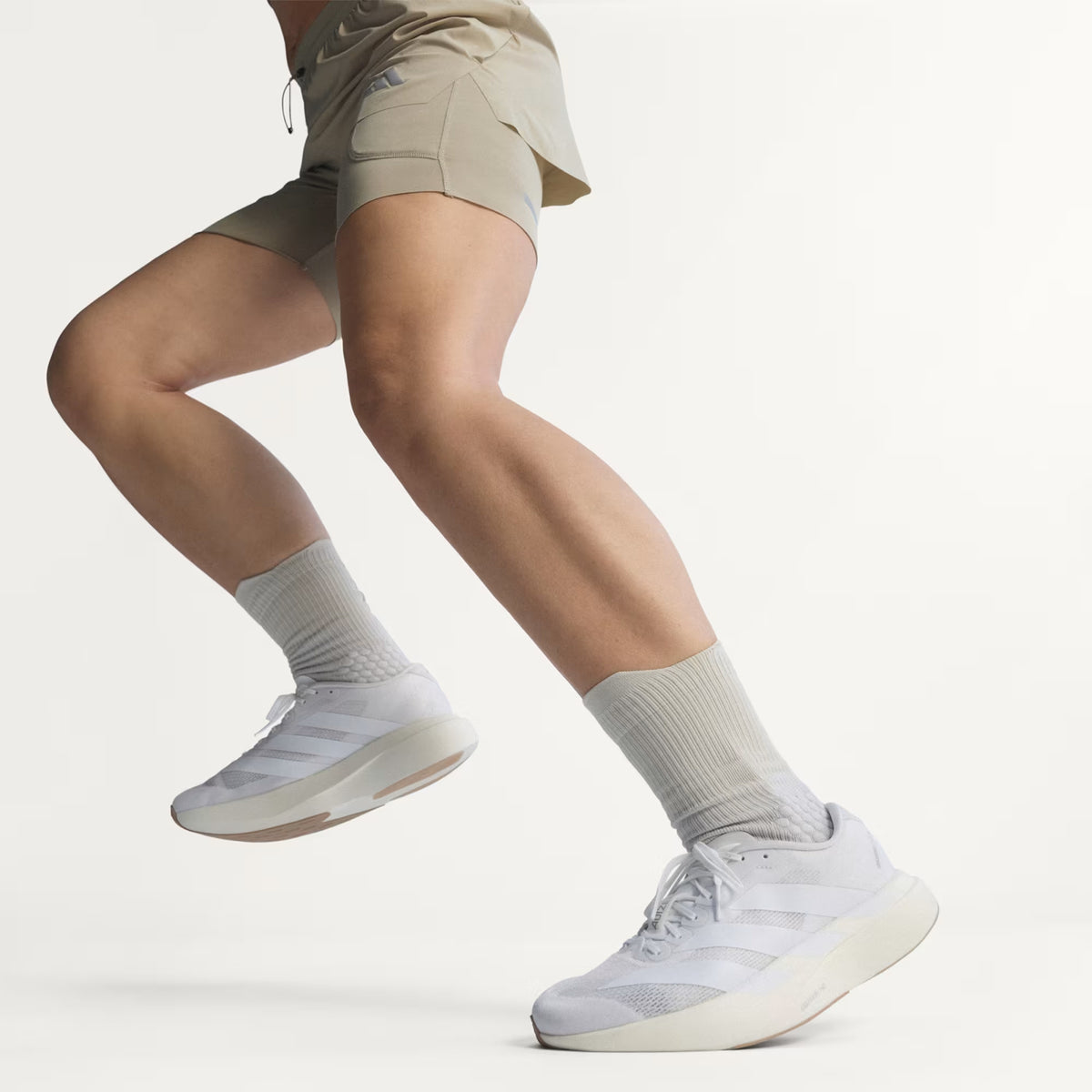 Women's adidas Adizero EVO SL Running Shoes Cloud White Cloud White Warm Sandstone worn by female runner in motion showing LIGHTSTRIKE PRO foam energy return with Continental rubber traction during tempo running