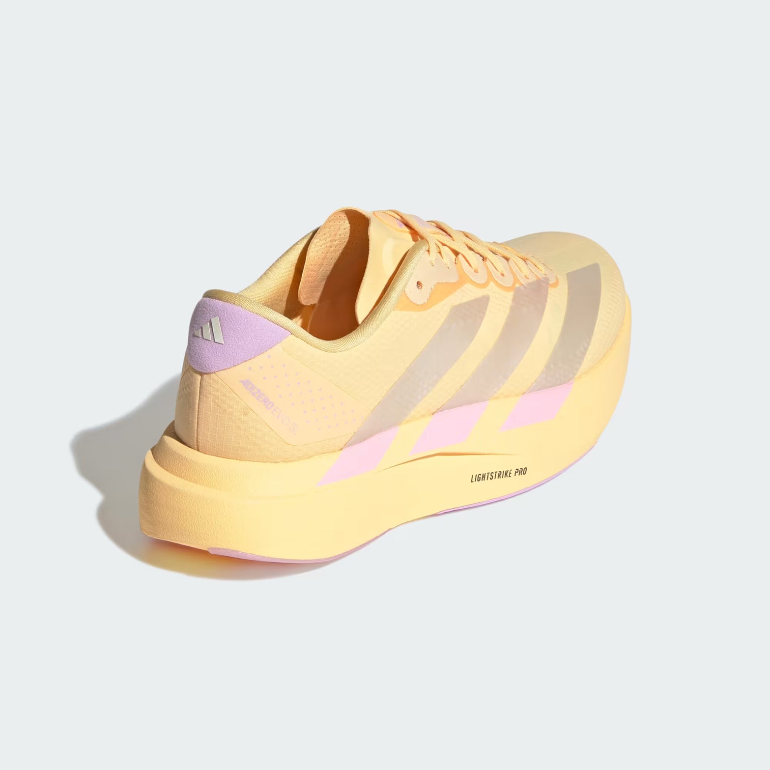 adidas Adizero EVO SL Woven women's running shoe in Ice Tangerine / Ice Gold Metallic / Bliss Lilac — angled rear view showing woven heel construction, ice gold metallic 3-Stripes and bliss lilac midsole contrast