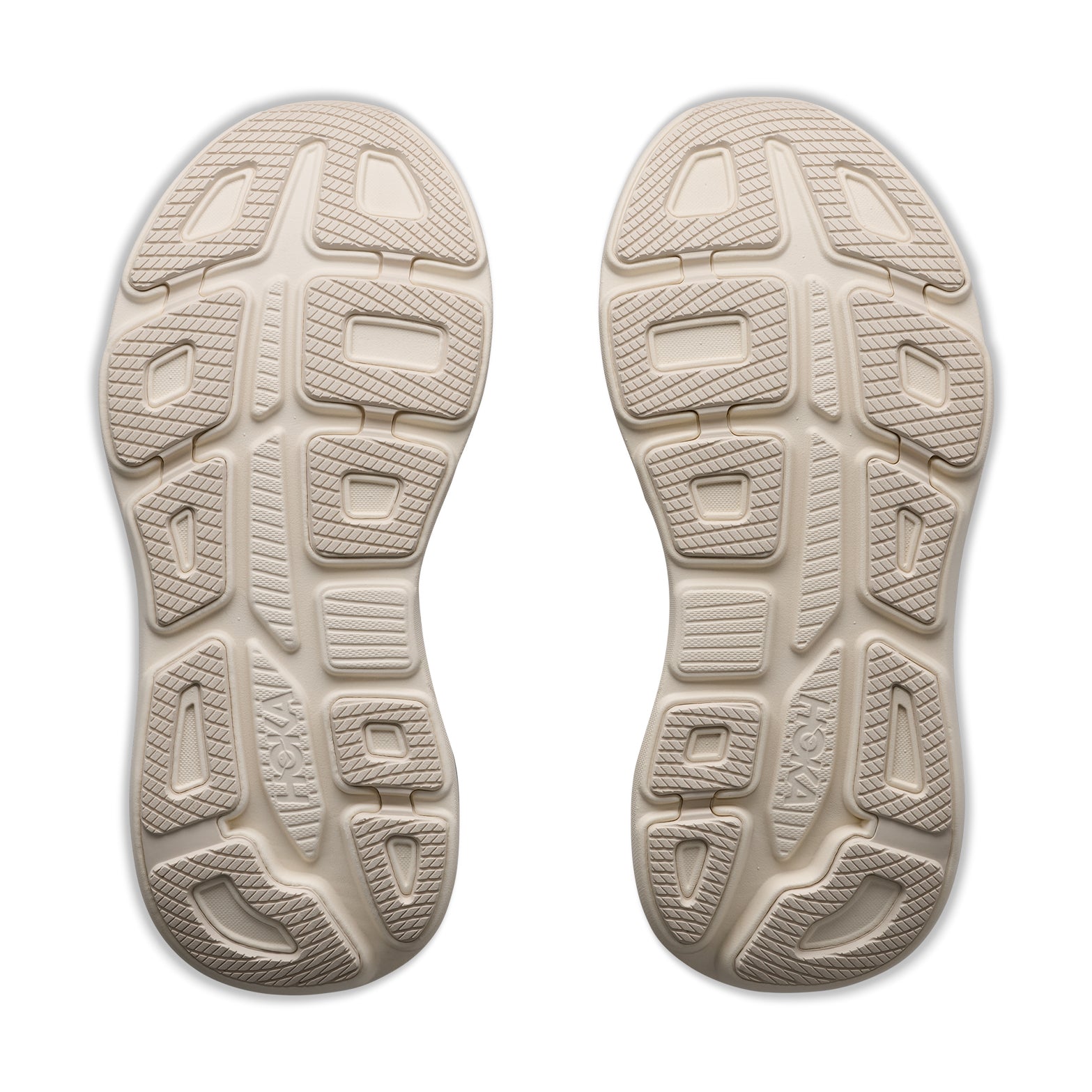 Two beige shoe soles with geometric tread patterns featuring rectangular and oval shapes, textured areas, and the Hoka brand name embossed near the heels, viewed from above on a white background—designed for all-day comfort as featured in the ultra-cushioned Women’s Bondi 9 Glimmers Running Shoes in Alabaster / Mineral Blue by Hoka.