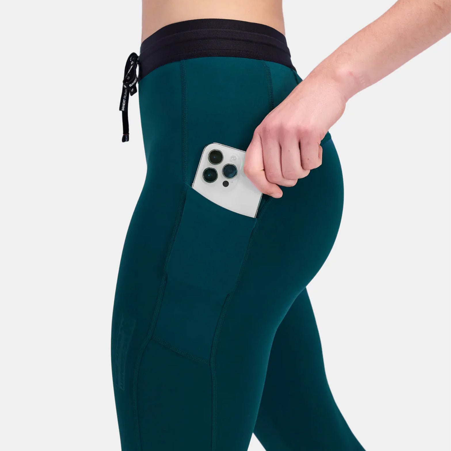Bandit winter running tights side view showing waterproof iPhone pocket on thigh with embossed branding