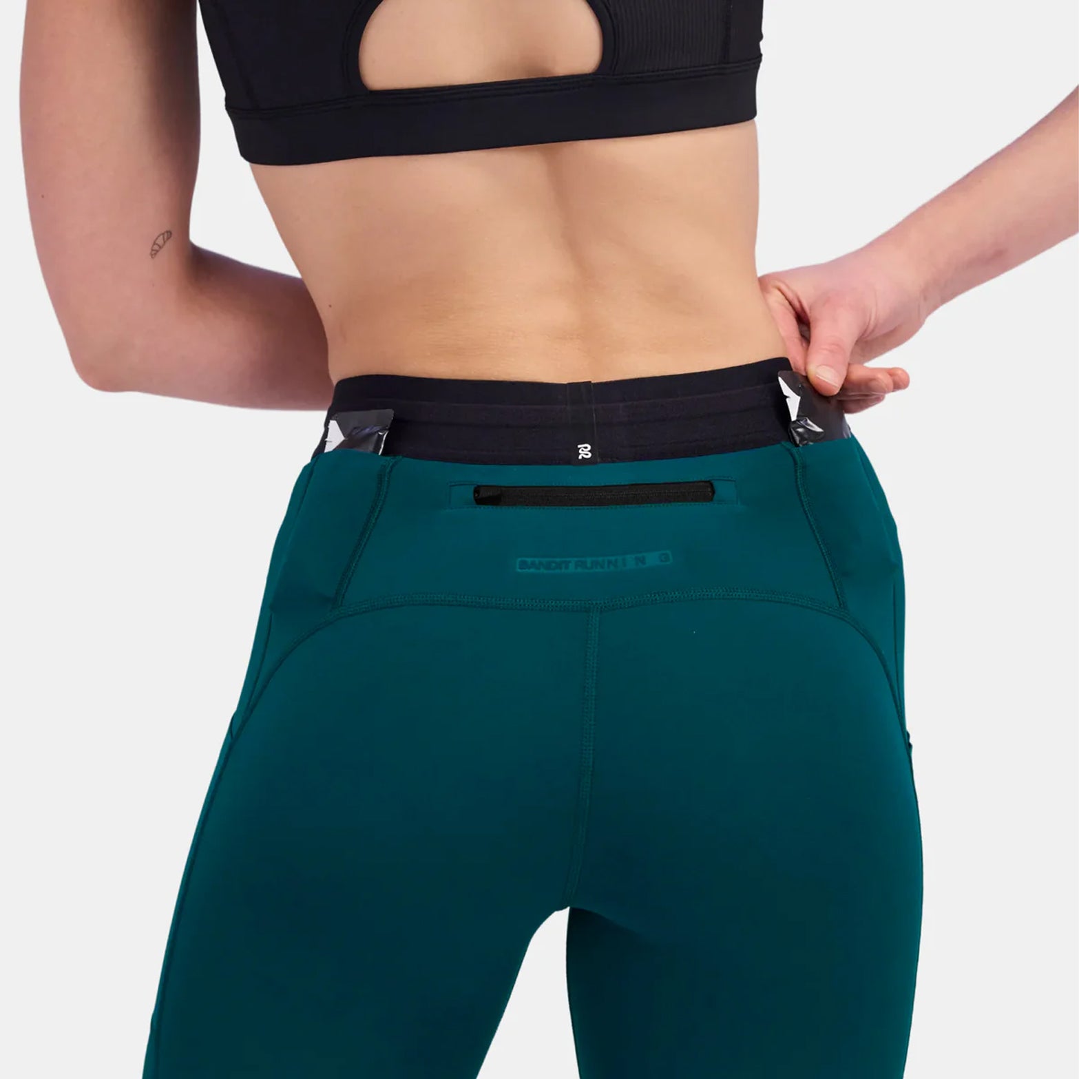 Bandit high-rise winter running tights back view on model highlighting  embossed branding & gel pockets