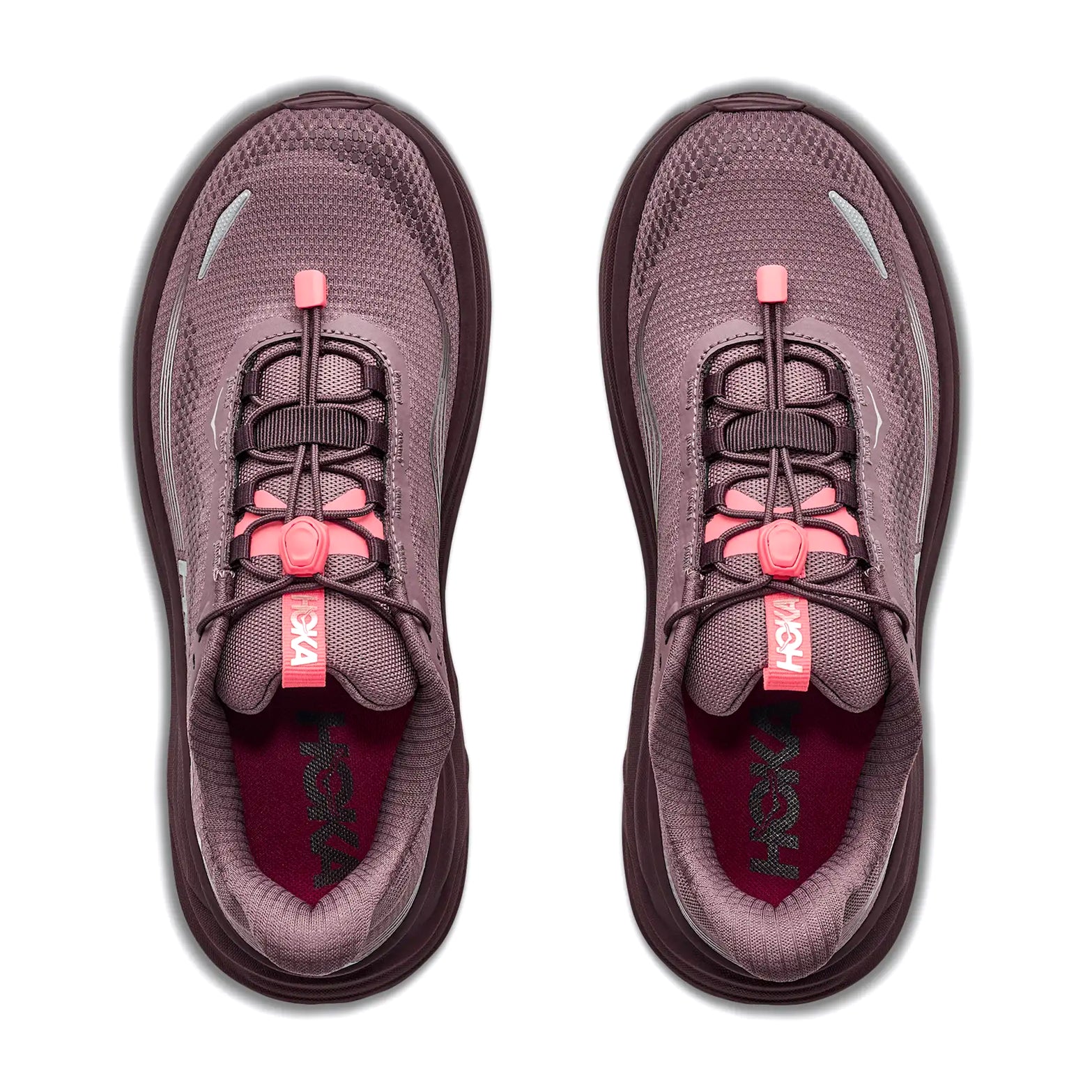 Two athletic shoes in smoky quartz and deep mauve with pink pull-tab laces are viewed from above on a white background. The insoles are dark red with Hoka branding visible inside each shoe, highlighting the new Women’s Clifton 11 GORE-TEX Running Shoes by Hoka—designed to keep your feet dry and comfortable in any weather.