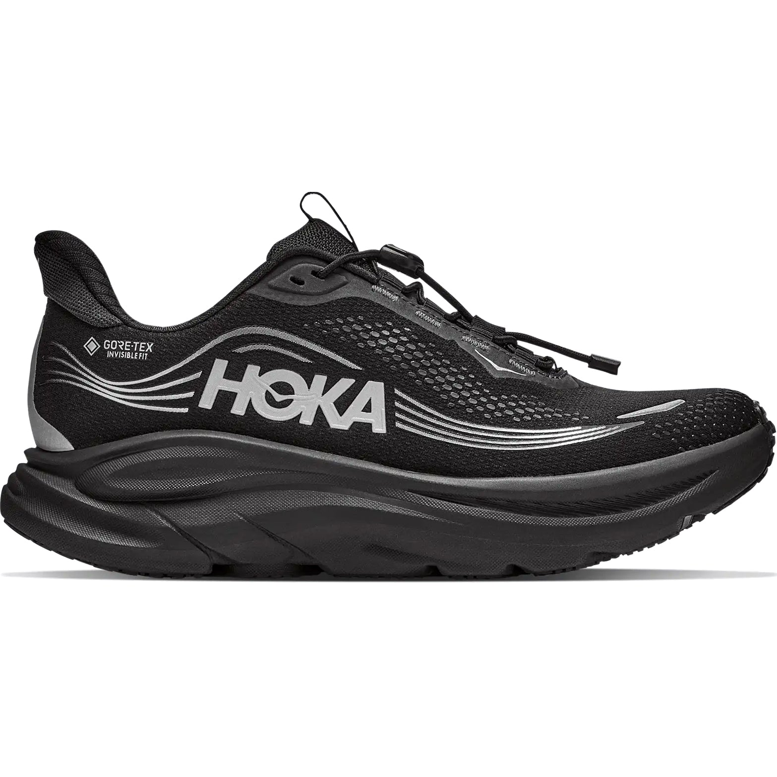 The Women’s Clifton 11 GORE-TEX Wide Fit Running Shoes in Black/Black by Hoka feature a sleek, modern design with silver accents, a thick sole, and the Hoka logo on the side along with Gore-Tex branding near the heel. These waterproof running shoes offer a lace-up system and are designed for a wide fit.