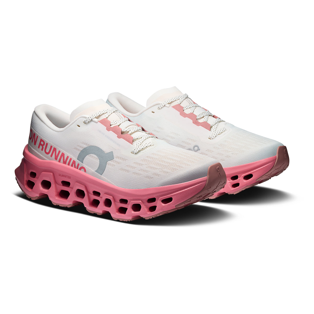 Women's On Cloudmonster 3 Running Shoes Ivory Camellia angled side view of pair showing triple-layer CloudTec foam with Helion cushioning, enhanced rocker shape and compressed rubber outsole for maximum cushioned responsive daily running
