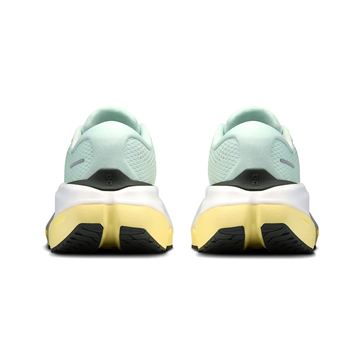 A pair of On Women’s Cloudrunner 3 Max LN1 Running Shoes in the Fresco / Gild colorway, featuring a light green upper with yellow and white soles, is shown from the back to display the Max Cushioning and Stability-Engineered CloudTec heel and sole patterns against a plain white background.