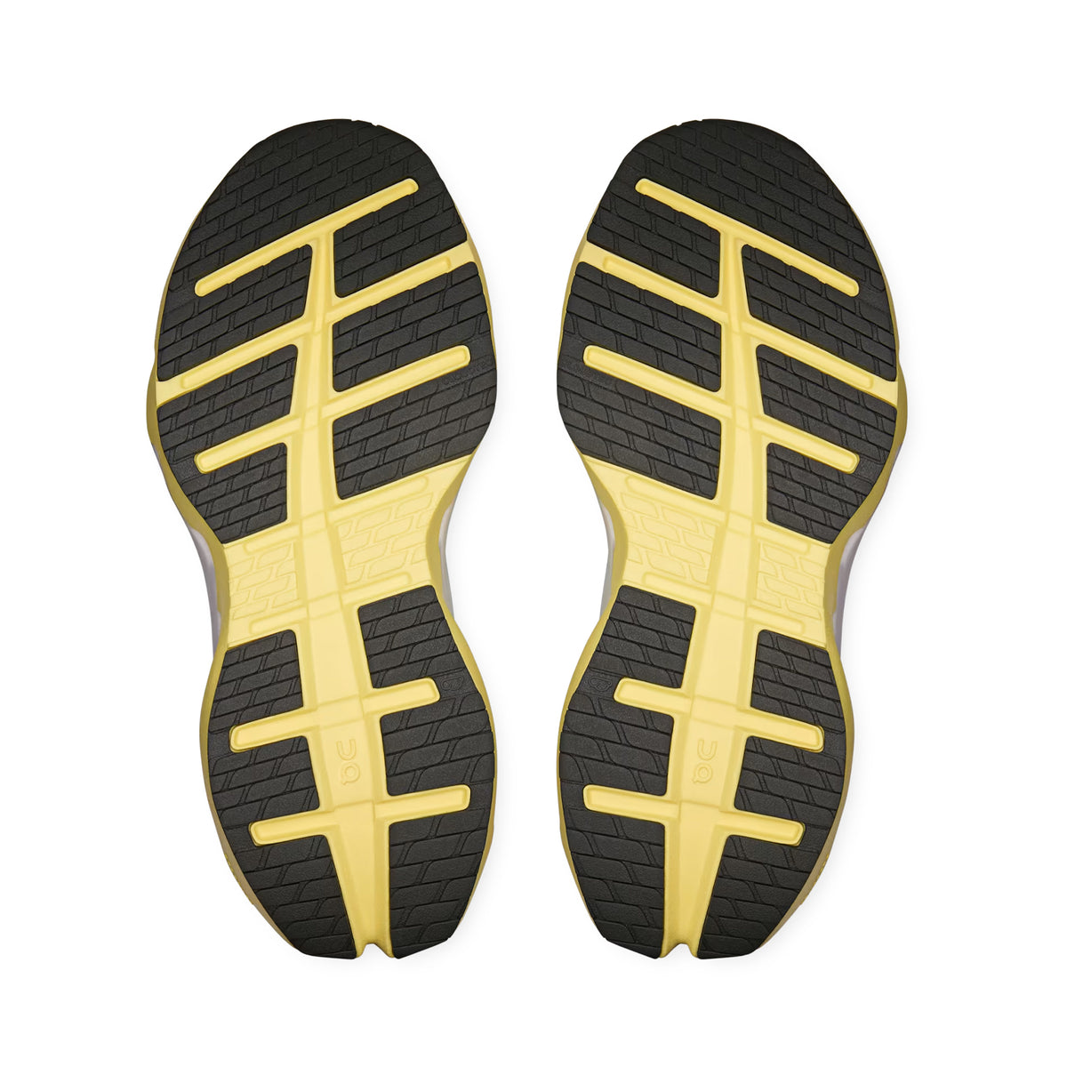 A pair of yellow and black athletic shoe soles with a geometric tread pattern, shown from the bottom against a white background. Designed for maximum comfort, these soles feature Stability-Engineered CloudTec technology inspired by the On Women’s Cloudrunner 3 Max LN1 Running Shoes in Fresco / Gild, delivering exceptional max cushioning for every stride.