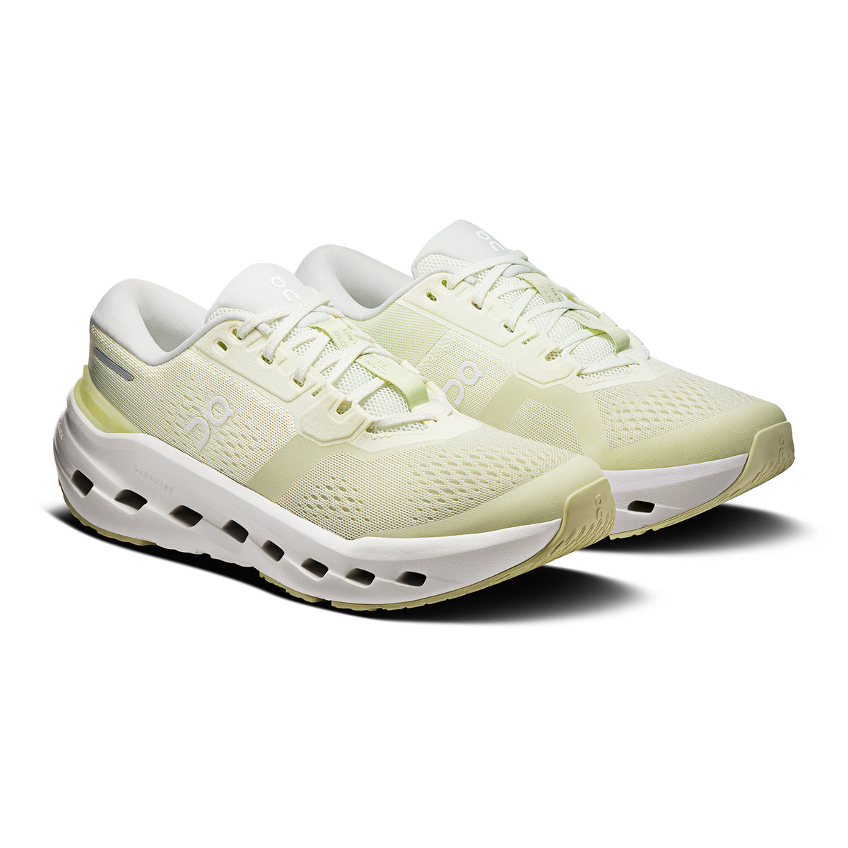 A pair of light yellow running shoes with white soles and mesh uppers, featuring small ventilation holes and a sleek, modern design. The laces and logo details are also light in color.