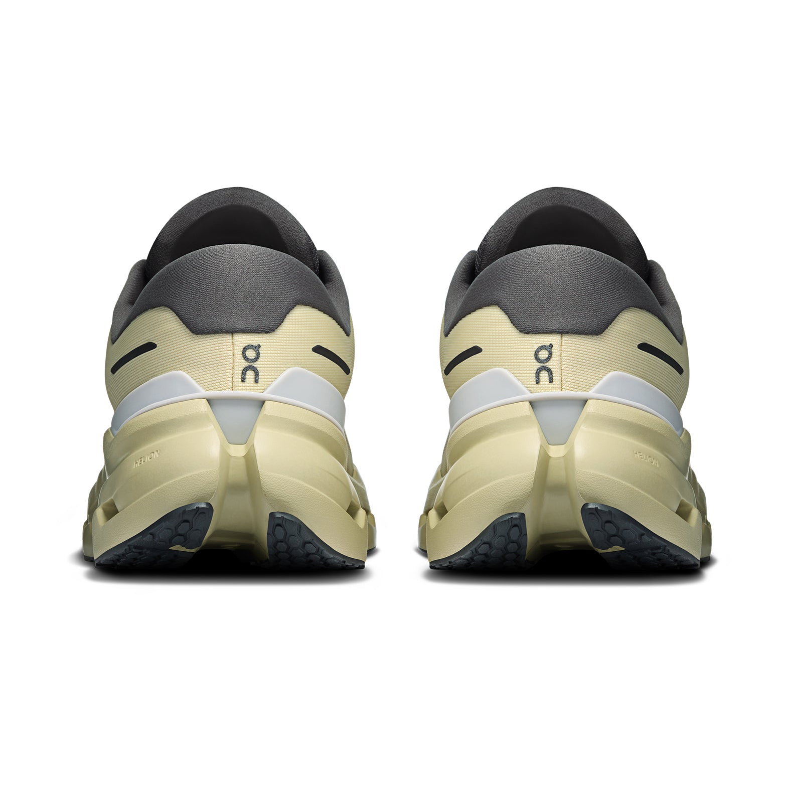 Rear view of a pair of Women’s Cloudrunner 3 WP Running Shoes in Pollon / Haze by On, showcasing thick, textured soles with CloudTec cushioning and the On logo on the heel—ideal waterproof athletic shoes designed for running in any weather.