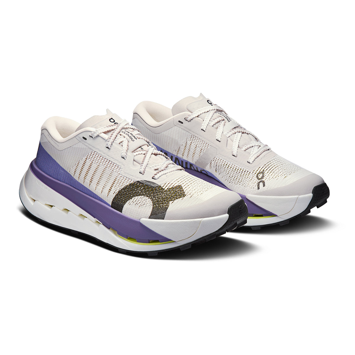 White athletic sneakers with purple, black, and yellow accents, mesh uppers, and thick soles. The shoes are angled to show both the sides and the tops, placed against a plain white background.