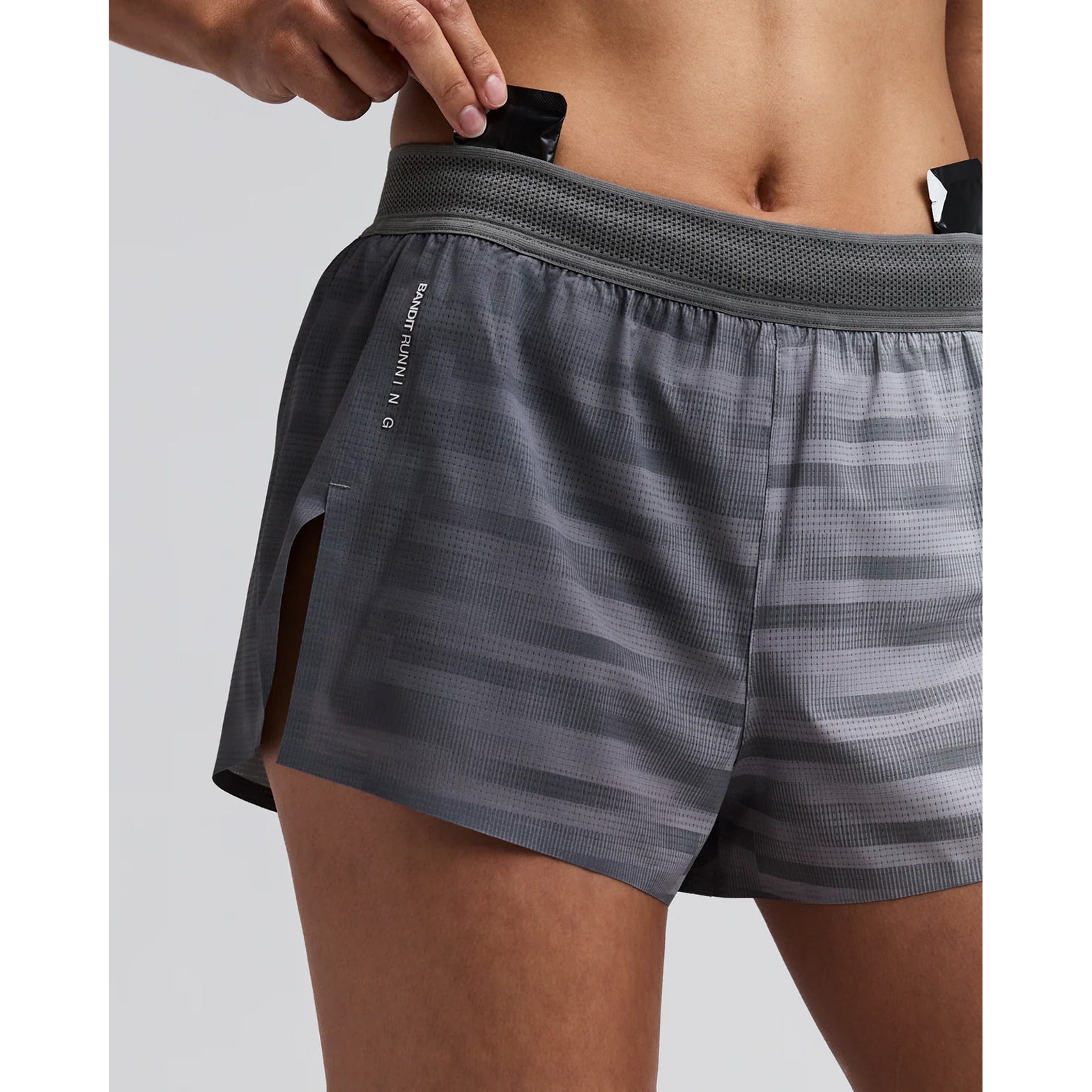 Women's Bandit CoolGrid 3 Inch Split Shorts Uneven Gradient Plaster Slate close-up of pocket system showing waterproof phone pocket, four gel pockets and key fob pocket with zero-bulk design for running essentials