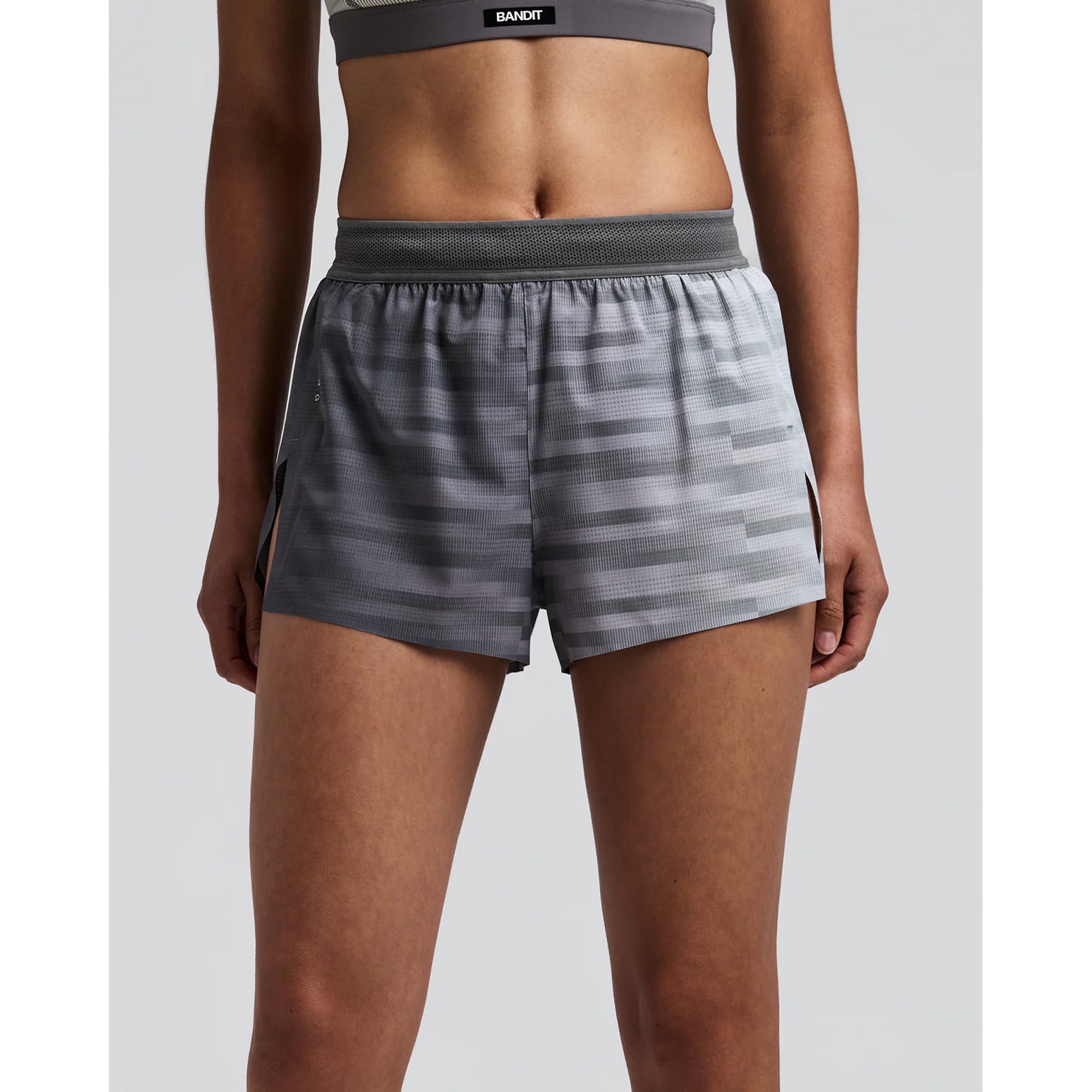 Women's Bandit CoolGrid 3 Inch Split Shorts Uneven Gradient Plaster Slate front view on female runner showing mid-rise fit with two-tone mesh waistband and internal drawstring for adjustable comfort