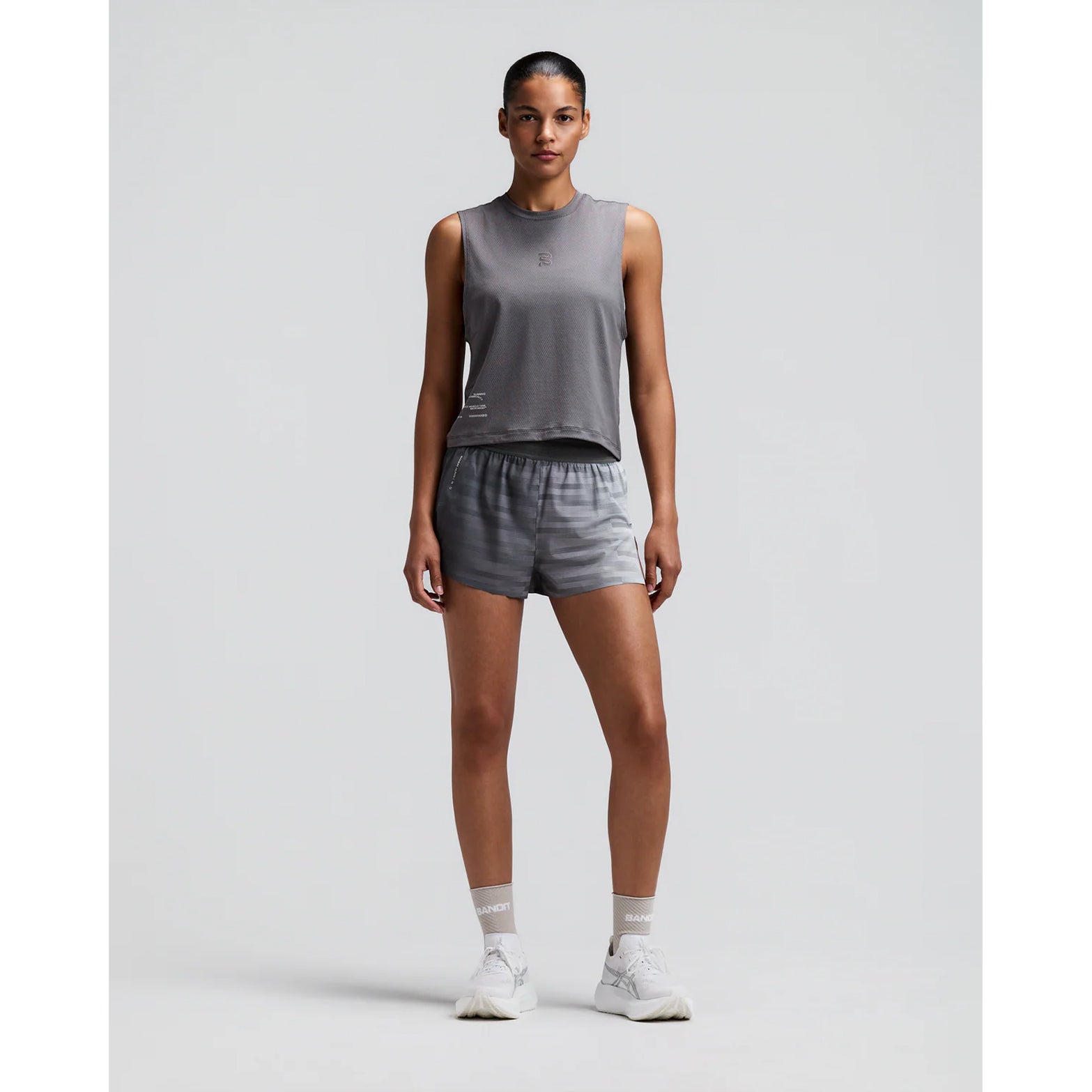 Women's Bandit CoolGrid 3 Inch Split Shorts Uneven Gradient Plaster Slate front full body view on female runner showing 3-inch split design with mid-rise fit and breathable CoolGrid fabric for road running and racing