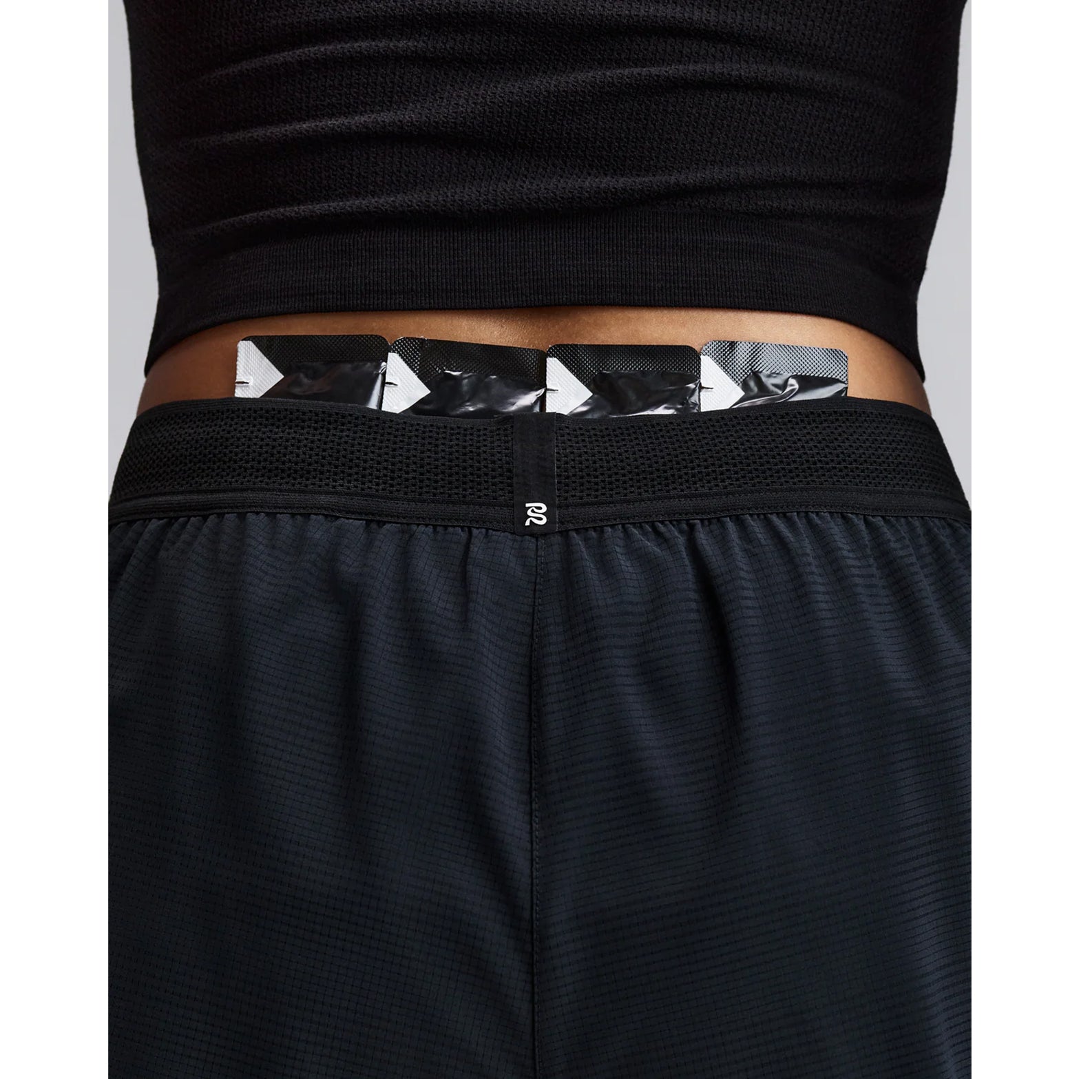 Women's Bandit CoolGrid 2-in-1 Run Short Black close-up of pocket system showing waterproof phone pocket on leg with four gel pockets and zero-bulk design for running essentials