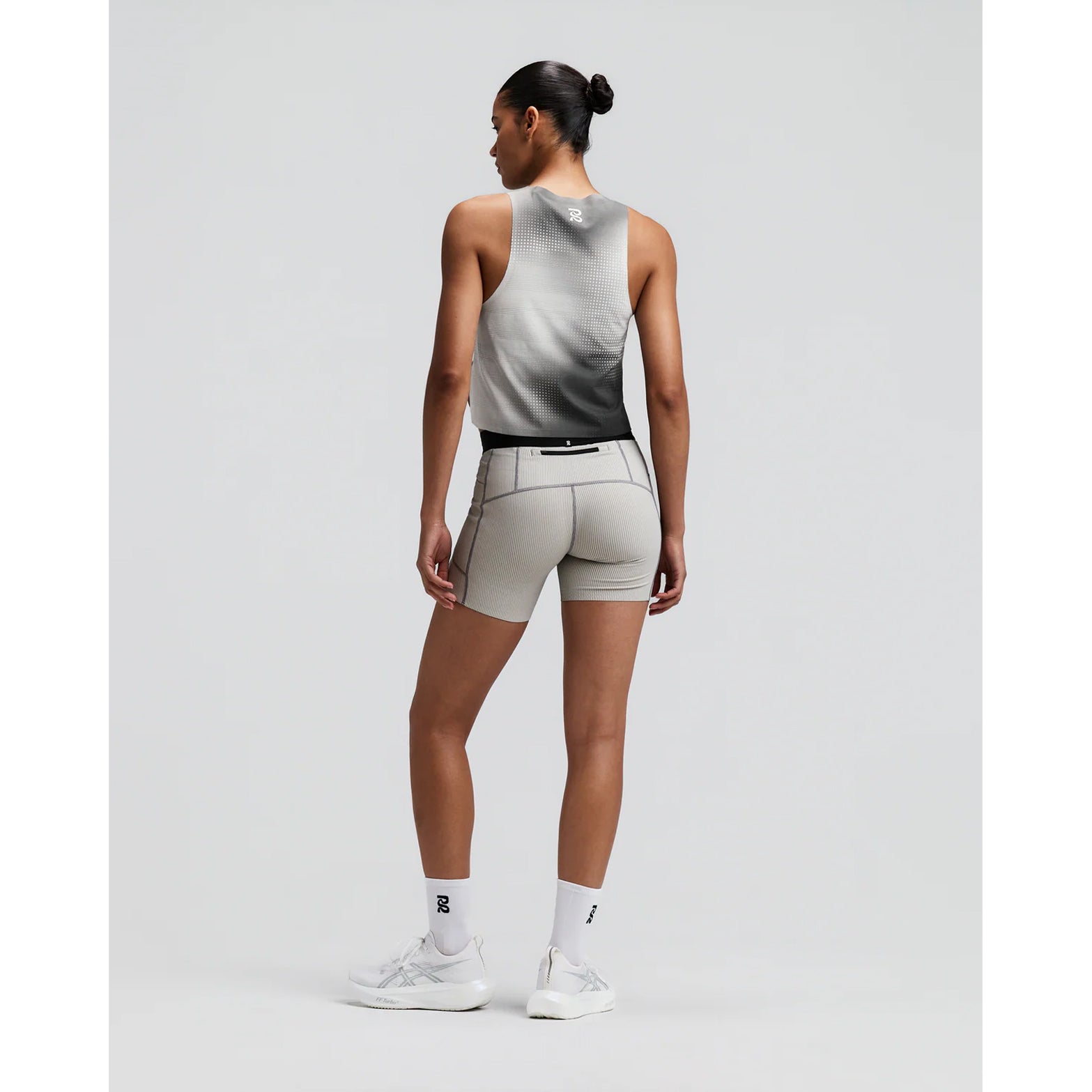 Women's Bandit CoolGrid Race Singlet Slate Multi back full body view on female runner showing bonded construction with side slits and two-tone reflective branding for breathable race day performance