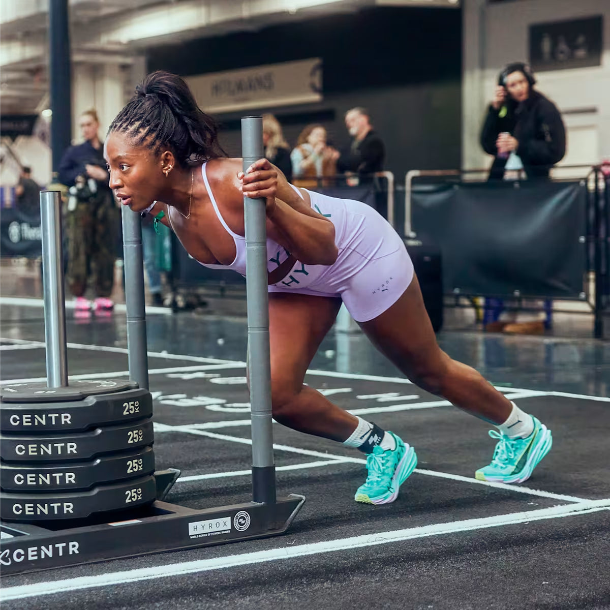 Women's Puma Deviate NITRO Elite 4 HYROX Running Shoes Intense Mint Light Lavender on female athlete showing purpose-built HYROX construction with NITROFOAM Elite foam and carbon fibre PWRPLATE for competitive fitness racing and running intervals