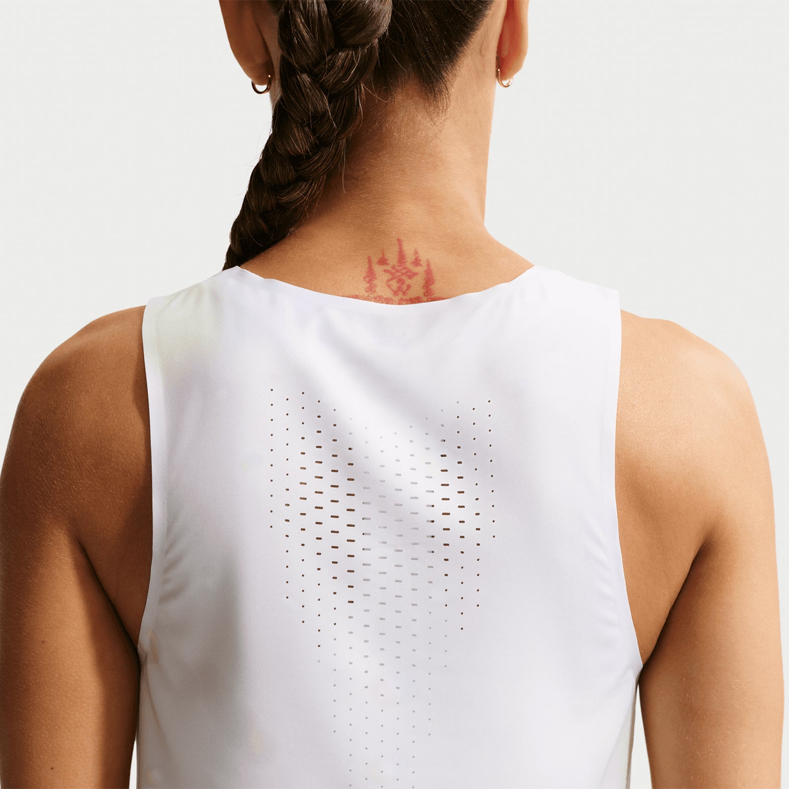 Women's Nike Dri-FIT ADV Cropped Running Vest Off White Black back view on female runner showing breathable construction with moisture management for training and racing