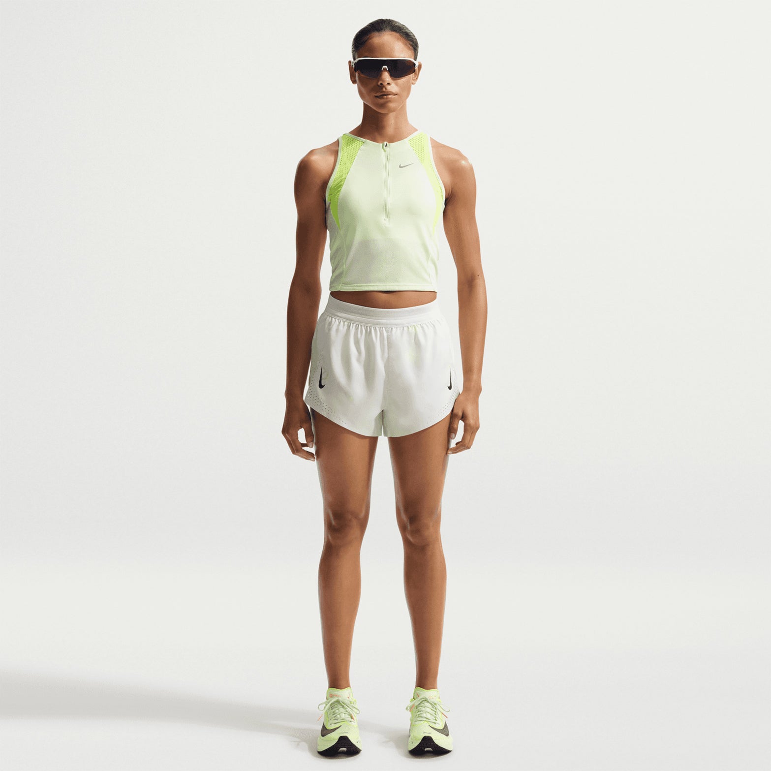 Women's Nike Dri-FIT ADV Mid-Rise 3 Inch Running Shorts Off White White Black front full body view on female runner showing mid-rise 3-inch shorts with Dri-FIT ADV technology for training and racing
