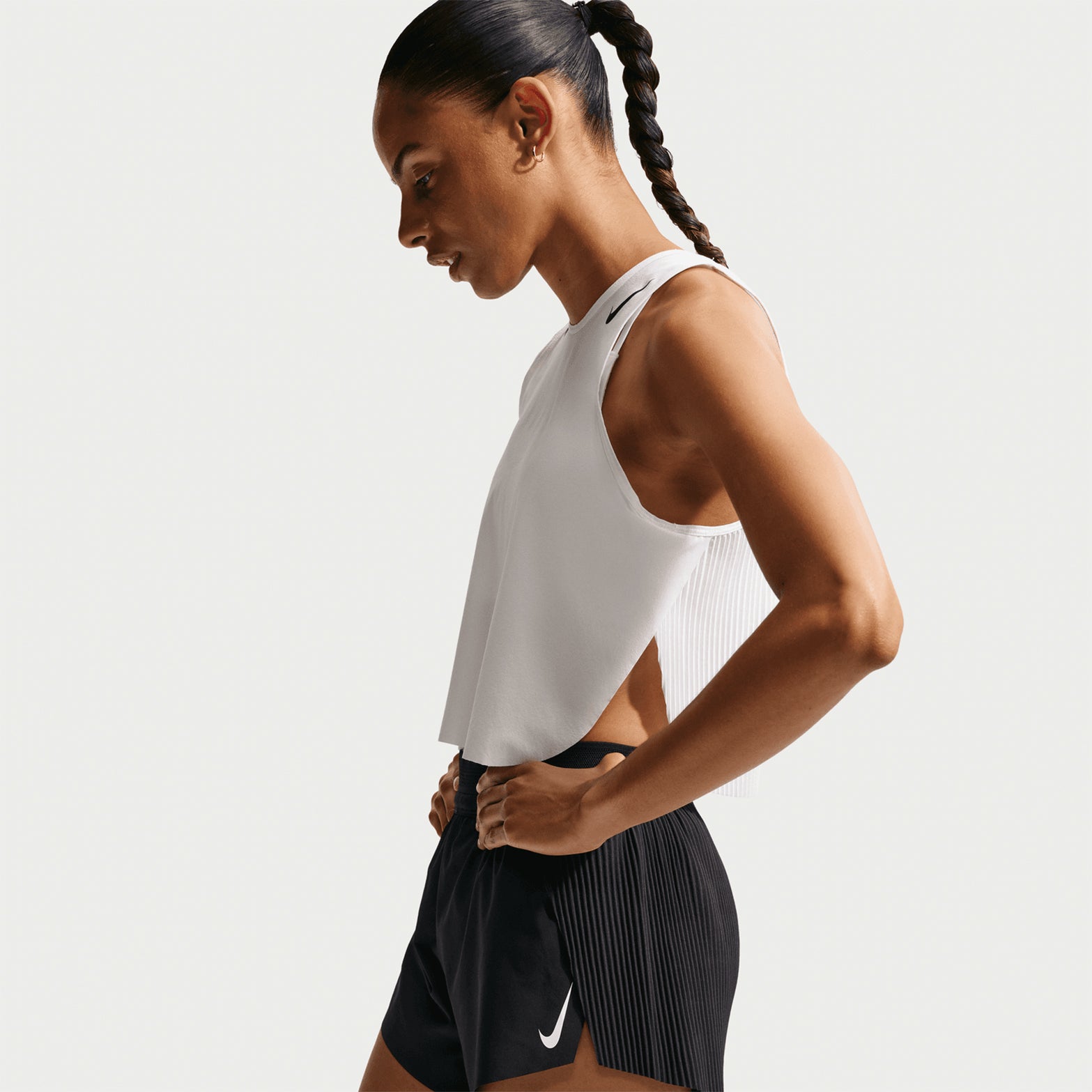 Women's Nike Dri-FIT AeroSwift ADV Mid-Rise 3 Inch Running Shorts Black White side view on female runner showing 3 inch inseam, split sides and mesh elastic waistband