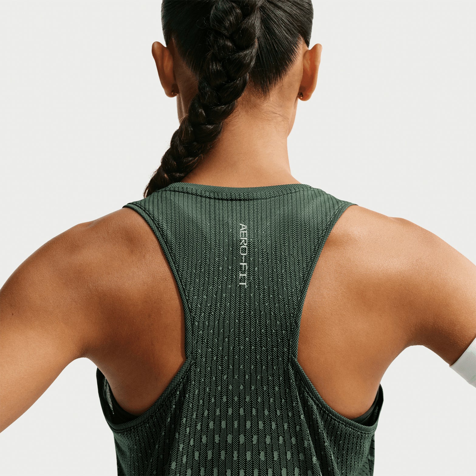 Women's Nike Dri-FIT Aeroswift Running Tank Black Light Green Spark Reflective Silver back view on female runner showing Aero-FIT airflow construction with reflective details for low-light running visibility