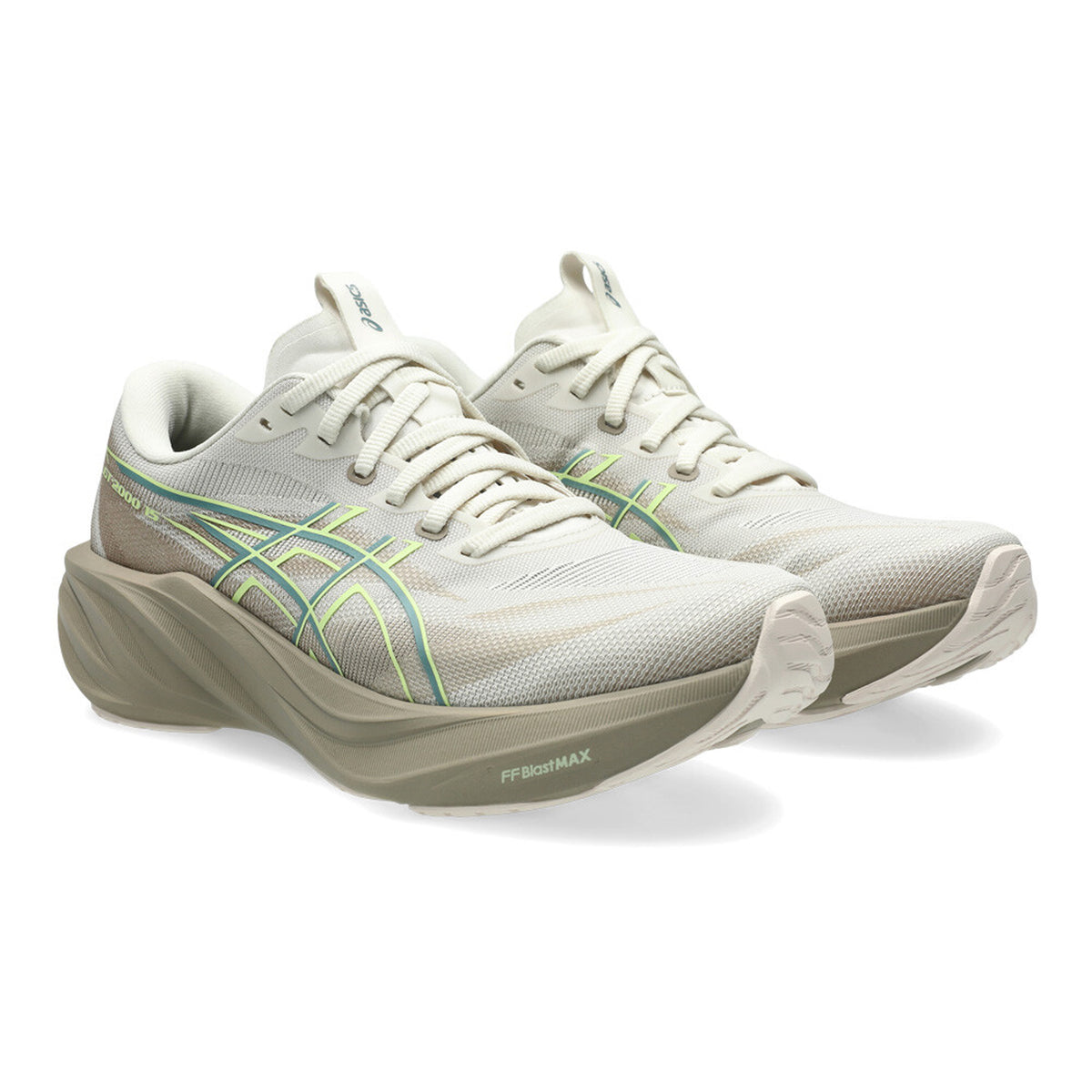 A pair of light beige Asics running shoes with green and gray accents, thick cushioned soles, and mesh uppers, displayed on a white background.