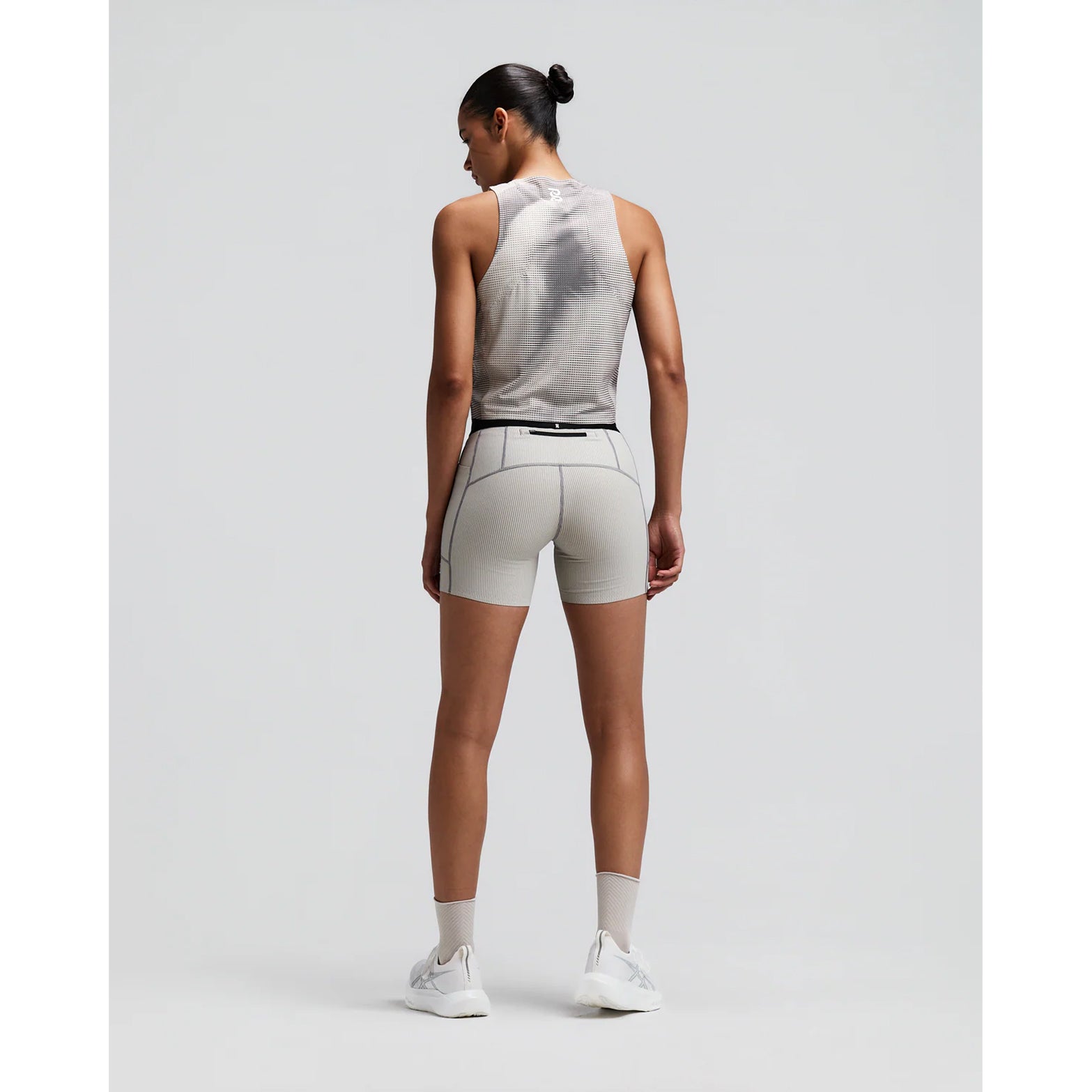 Women's Bandit GeoMesh Race Singlet Slate Plaster back full body view on female runner showing bonded construction with GeoMesh four-way stretch and moisture-wicking fabric for breathable race day performance
