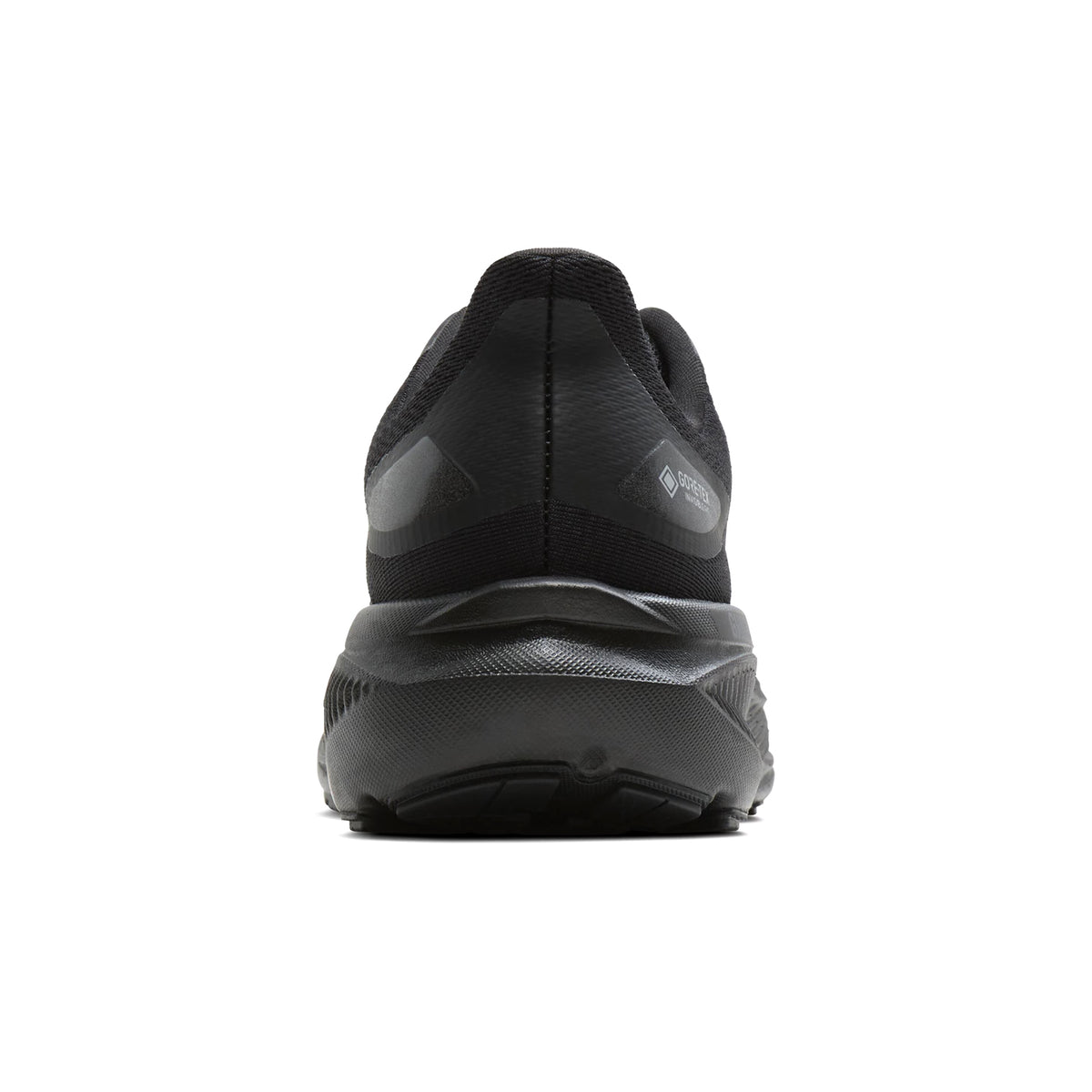 Black athletic shoe viewed from the back, featuring a thick, textured sole and mesh upper. Centered on a white background, the Brooks Women’s Ghost 18 GORE-TEX Running Shoes in Black/Black/Ebony provide comfort and durability for everyday runs.