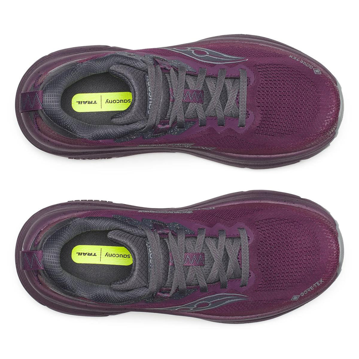 A pair of Saucony Women’s Guide TR GTX Eggplant running shoes in purple with gray laces and lining, viewed from above. Bright yellow insoles are labeled Saucony Trail.