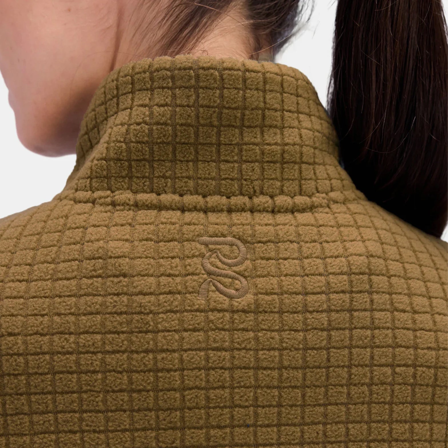 Bandit MacroSoft Grid Quarter Zip back neck closeup featuring embroidered logo and flatlock seaming